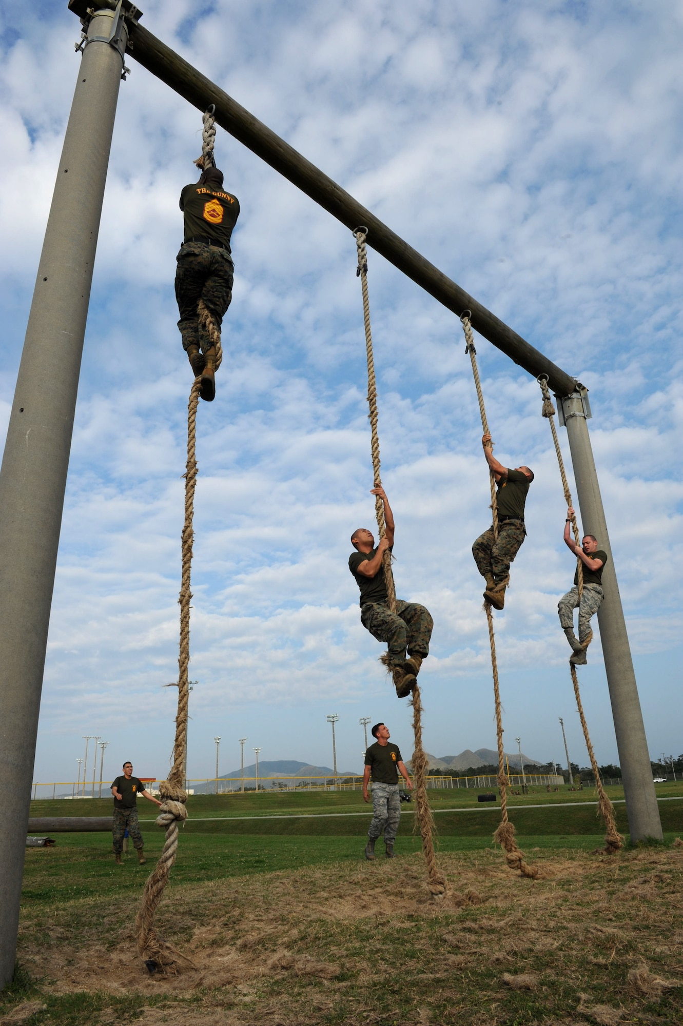 U.S. Air Force Airmen and Marine Corps Marines climb ropes during a confidence course on Camp Hansen, Japan, Feb. 14, 2013. Thirty-three senior NCO service members participated in the course, followed by a squad competition where three teams competed against each other. (U.S. Air Force photo/Airman 1st Class Hailey R. Davis)