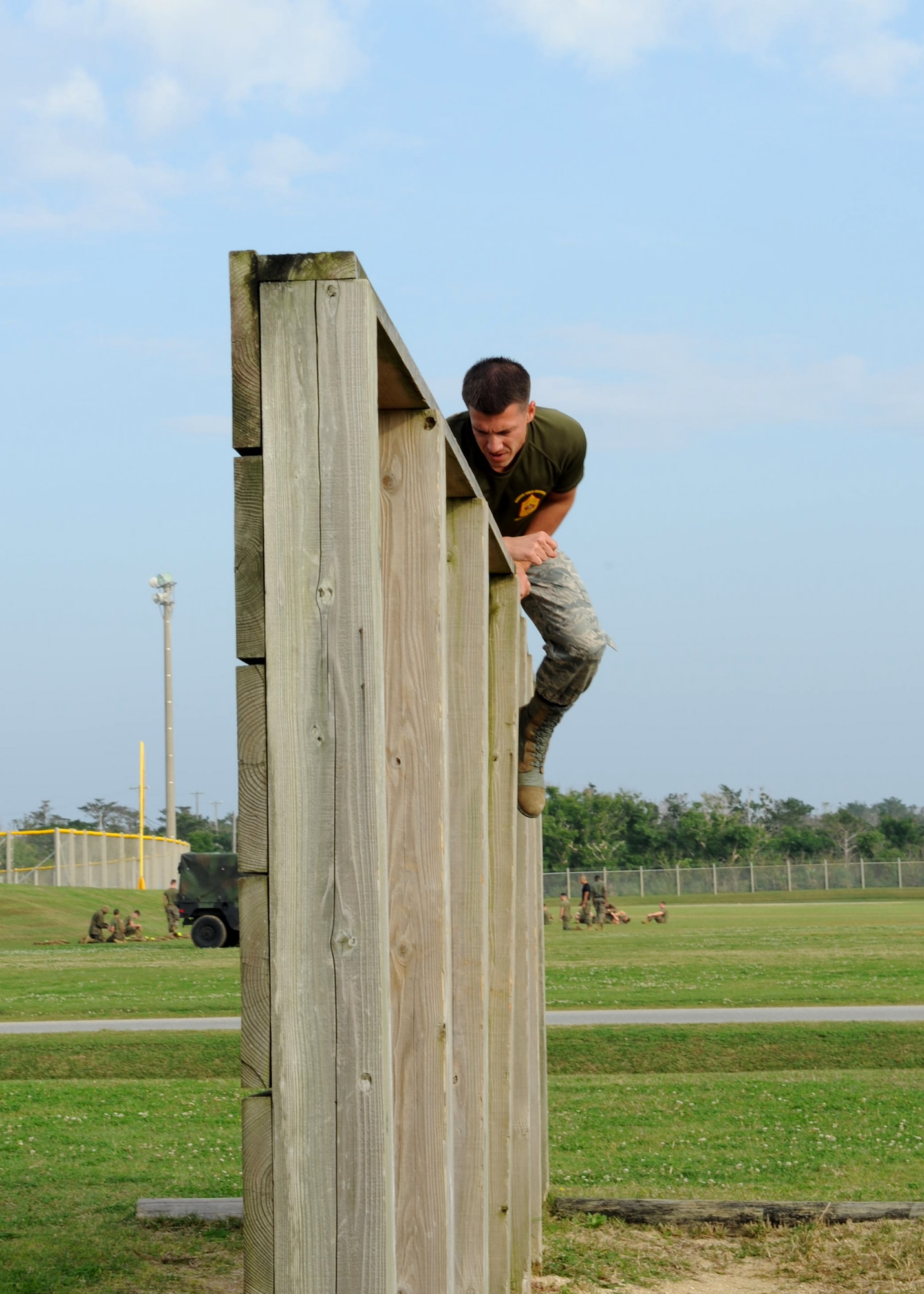 U.S. Air Force Master Sgt. Mark James, Erwin Professional Military Education Airman Leadership School commandant, climbs over a wall during a confidence course on Camp Hansen, Japan, Feb. 14, 2013. James is one of five U.S. Air Force senior NCOs who were chosen to participate in the U.S. Marine Corps Staff NCO Academy Advanced Course on Camp Hansen. (U.S. Air Force photo/Airman 1st Class Hailey R. Davis)