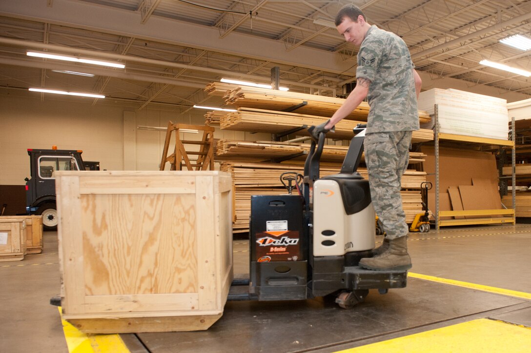 Airman 1st Class Matthew Schnobrich, 28th Logistics Readiness Squadron storage and issue technician, moves a palletized video monitor onto a weight scale in the 28th LRS Traffic Management office on Ellsworth Air Force Base, S.D., Feb. 12, 2013. Storage and issue Airmen are responsible to supply other organizations on base with items and equipment they need to complete their mission. (U.S. Air Force photo by Airman 1st Class Kate Thornton-Maurer/Released)
