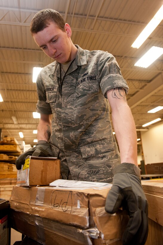 Airman 1st Class Matthew Schnobrich, 28th Logistics Readiness Squadron storage and issue technician, unloads packages from central storage in the 28th LRS Traffic Management office on Ellsworth Air Force Base, S.D., Feb. 12, 2013. Storage and issue Airmen manage more than 17,000 items, ranging from major aircraft components to nuts and bolts. (U.S. Air Force photo by Airman 1st Class Kate Thornton-Maurer/Released)