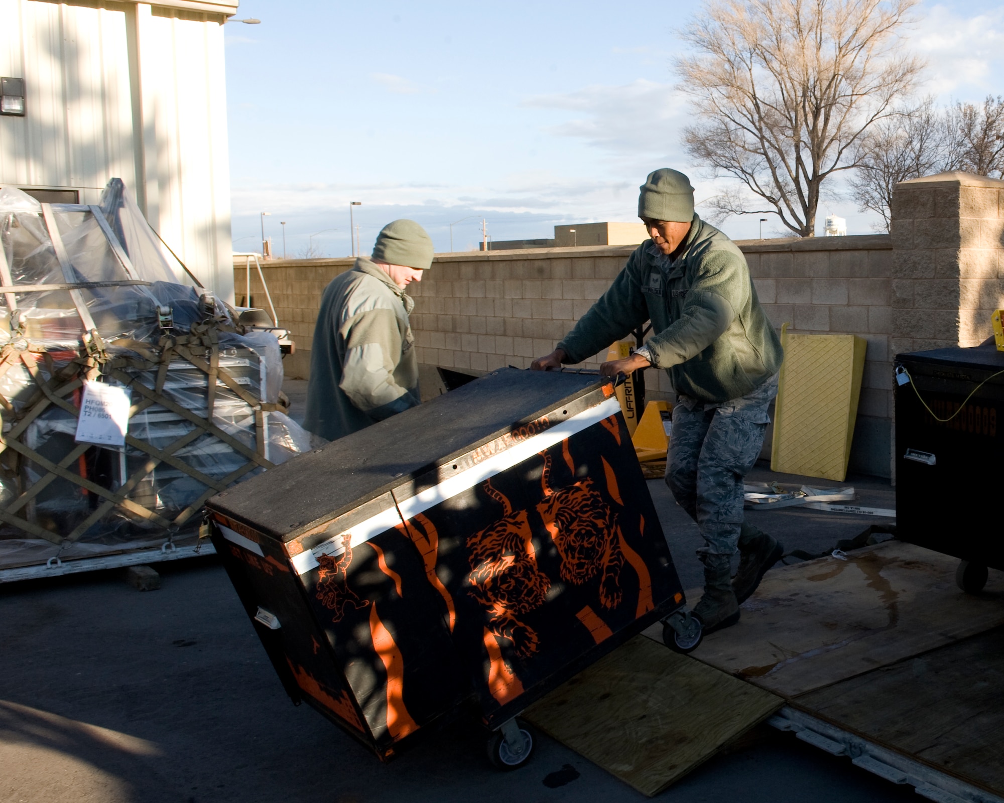 U.S. Air Force Senior Airman Courtney Williams, 391st Aircraft Maintenance Unit crewchief, unloads a toolbox off of a pallet Feb. 19, 2013, at Mountain Home Air Force Base, Idaho. Once unloaded, other Airmen inspected the toolboxes to make sure all equipment was accounted for. (U.S. Air Force photo/Airman 1st Class Brittany Chase)