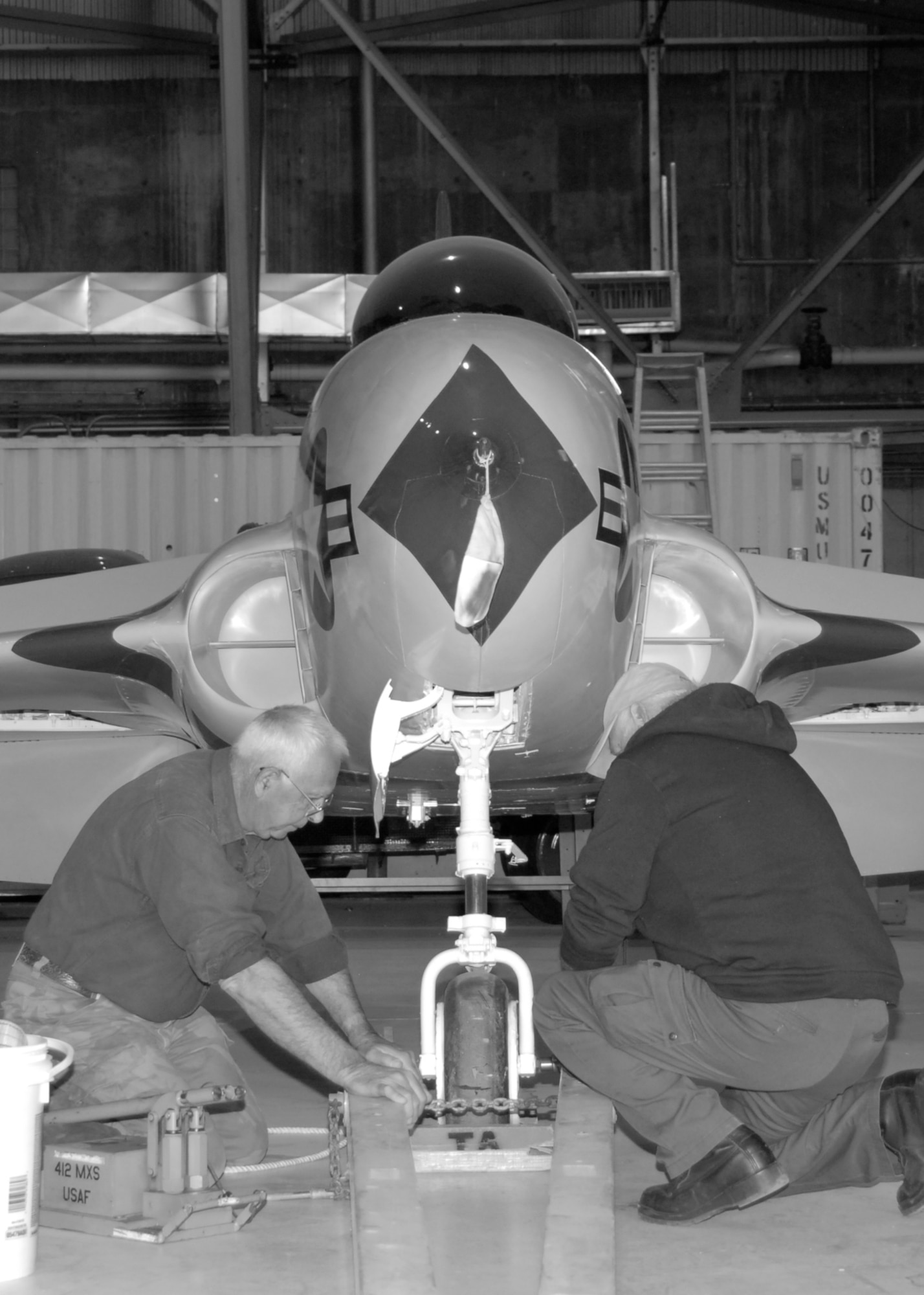 Volunteers prepare to relocate the X-4 Bantam. (U.S. Air Force Photo by Laura Mowry)