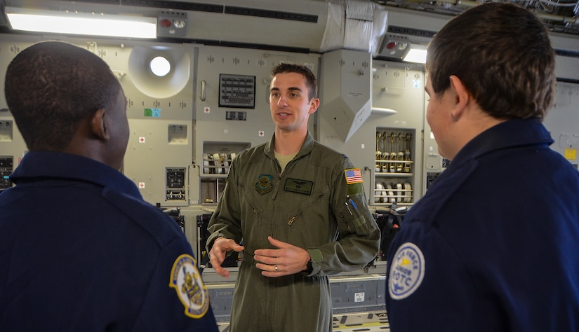 Captain Matt Van Osterom, 16th Airlift Squadron pilot, talks about pilot training to two U.S. Air Force Junior Reserve Officer Training Corps students from R.B. Stall High School Feb. 19, 2013, aboard a C-17 Globemaster III at Joint Base Charleston – Air Base, S.C.  More than 20 students visited the air base to get a firsthand experience of what Airmen do on a day-to-day basis. These tours help endorse strong community ties to the local population and help recruit future leaders of tomorrow’s Air Force. (U. S. Air Force photo/Airman 1st Class Jared Trimarchi) 
