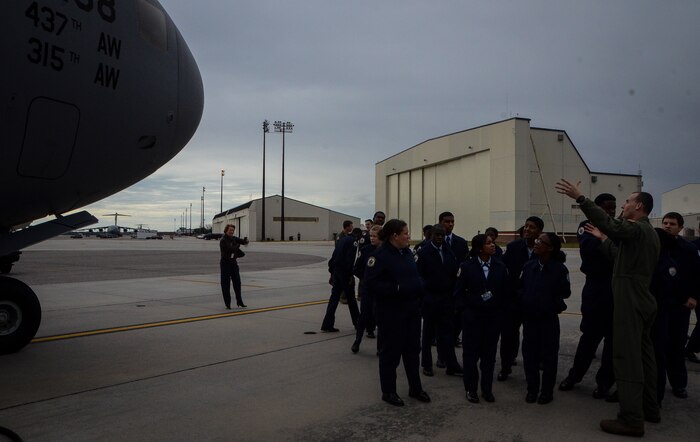 Captain. C.J. Burdon, 16th Airlift Squadron pilot, explains the capabilities of the C-17 Globemaster III to U.S. Air Force Junior Reserve Officer Training Corps students from R.B. Stall High School Feb. 19, 2013, at Joint Base Charleston – Air Base, S.C.  More than 20 students visited the air base to get a firsthand experience of what Airmen do on a day-to-day basis. These tours help endorse strong community ties to the local population and help recruit future leaders of tomorrow’s Air Force. (U. S. Air Force photo/Airman 1st Class Jared Trimarchi) 