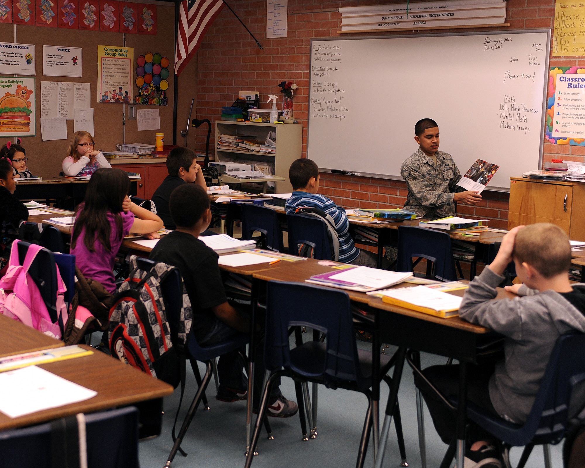 U.S. Air Force Airman Emanuel Bravo, 48th Rescue Squadron aircrew equipment apprentice reads to children from Irene Erickson Elementary School in Tucson, Ariz., Feb. 13, 2013. Airmen from across Davis-Monthan Air Force Base volunteer in the Tucson community on a regular basis. (U.S. Air Force photo by Airman 1st Class Christine Griffiths/Released) 