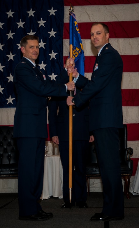 Colonel Trevor Nitz, 437th Operations Group commander, passes the squadron guidon to Lt. Col. Matthew Leard, 437th Operations Support Squadron incoming commander, during the 437th OSS Change of Command ceremony Feb. 15, 2013, at Joint Base Charleston – Air Base, S.C. Lieutenant Colonel Mark Fuhrmann relinquished command of the 437th OSS to Leard. The passing of the guidon symbolizes the changing of a command.. (U.S. Air Force photo/ Senior Airman Dennis Sloan)