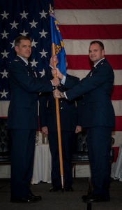 Colonel Trevor Nitz, 437th Operations Group commander, receives the squadron guidon from Lt. Col. Mark Fuhrmann, 437th Operations Support Squadron outgoing commander, during the 437th OSS Change of Command ceremony Feb. 15, 2013, at Joint Base Charleston – Air Base, S.C. Lieutenant Colonel Matthew Leard took command of the 437th OSS. (U.S. Air Force photo/ Senior Airman Dennis Sloan)