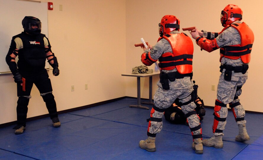 Staff Sgt.'s Jimmie Stewart and Joshua Johnson, 2nd Security Forces Squadron, engage a gunman simulated by Tech. Sgt. William Townsend, 2 SFS unit training intstuctor, during the practical portion of expandable baton training on Barksdale Air Force Base, La., Feb. 15. After the classroom portion was completed, Airmen were challenged with various scenarios in which they had to use the techniques learned during the class. (U.S. Air Force photo/Airman 1st Class Andrew Moua)