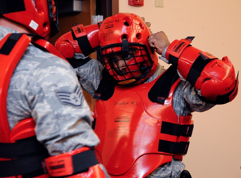 Staff Sgt. Raymond Perry, 2nd Security Forces Squadron, dons protective gear prior to beginning the application of force section of expandable baton training on Barksdale Air Force Base, La., Feb. 15. After being taught striking techniques and proper draw of a baton, Airmen in the class applied what they learned by sparring against each other. (U.S. Air Force photo/Airman 1st Class Andrew Moua)