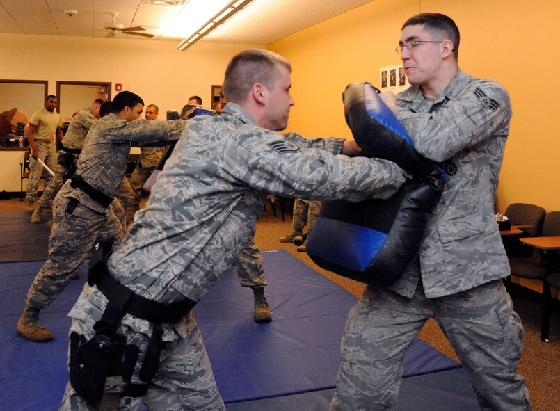Staff Sgt. Bryan Dickerson, 2nd Security Forces Squadron, demonstrates an upper chest strike against Senior Airman Cody Rothery, 2 SFS, during expandable baton training on Barksdale Air Force Base, La., Feb. 15. Along with learning a variety of strikes and techniques with the baton, Airmen learned unarmed techniques in the event they are unarmed or are unable to draw their baton. (U.S. Air Force photo/Airman 1st Class Andrew Moua)