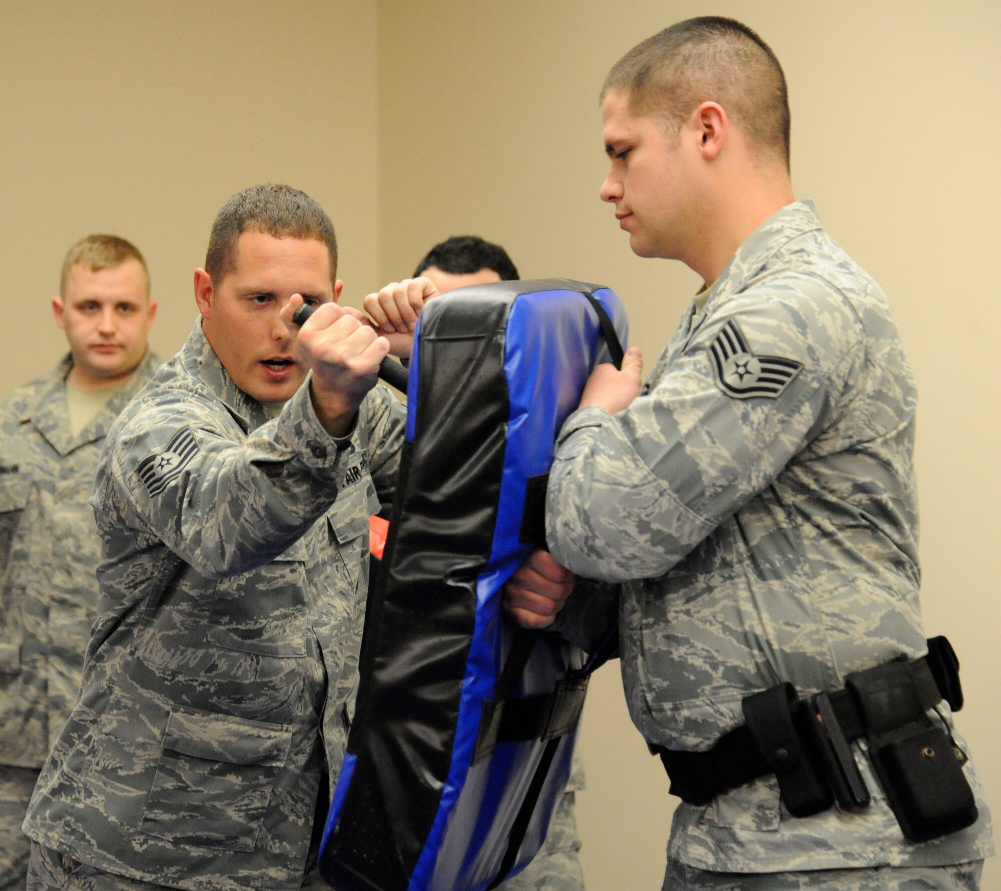 Tech. Sgt. William Townsend, 2nd Security Forces Squadron unit training instructor, demonstrates techniques with an expandable baton during training on Barksdale Air Force Base, La., Feb. 15. The class taught multiple techniques such as a variety of strikes while armed and unarmed and how to disable an assailant. (U.S. Air Force photo/Airman 1st Class Andrew Moua)