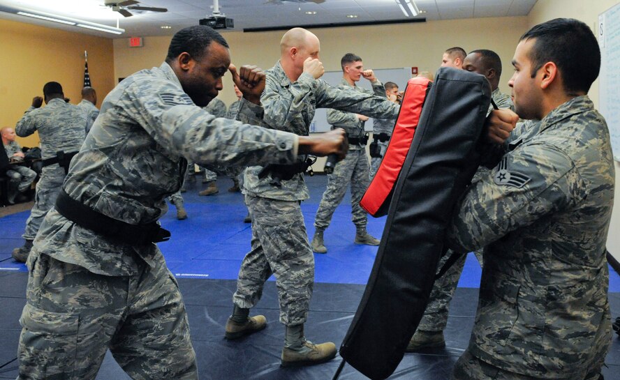 Staff Sgt. Marcus Blue, 2nd Security Forces Squadron, throws a punch toward Senior Airman Aldo Felici, 2 SFS, during expandable baton training on Barksdale Air Force Base, La., Feb. 15. The class familiarized Airmen with the baton in order for it to be used effectively while on duty if the situation called for it. (U.S. Air Force photo/Airman 1st Class Andrew Moua)