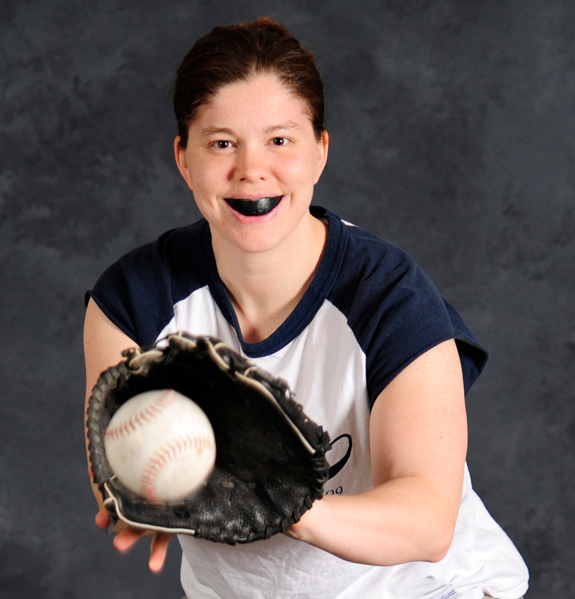 Staff Sgt. Maria Bowman catches a softball at Scott Air Force Base Feb. 16.  Due to a previous softball accident where she took a line drive to the face, she now wears a mouthguard to protect her teeth.  (U.S. Air Force photo/Staff Sgt. Maria Bowman) 