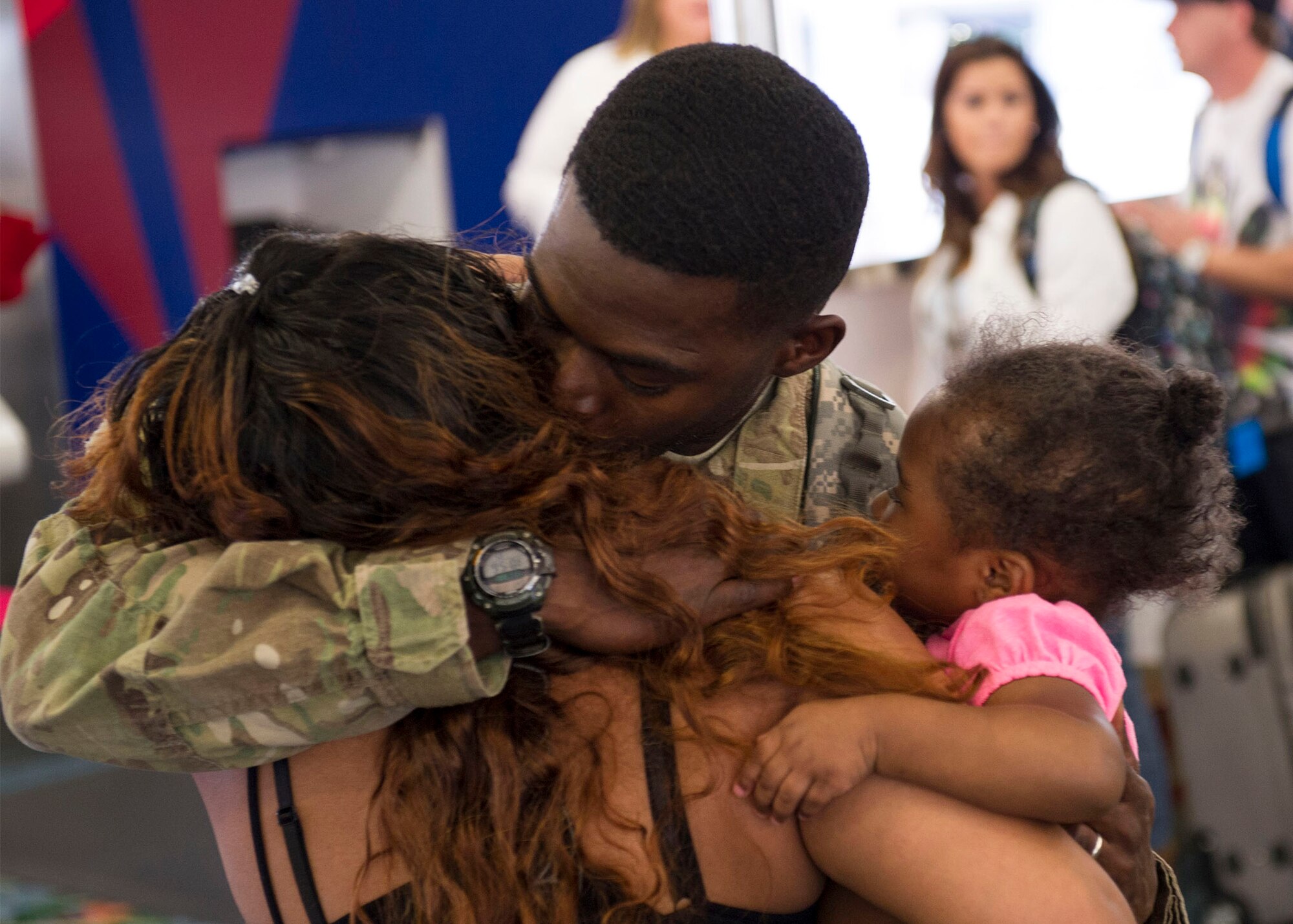 Staff Sgt. Jason Lester, a Power Pro Journeyman, assigned with the 45th Civil 
Engineer Squadron, shares hugs with his wife, Yvonne, and daughter Ja'Nelle, 
2, as the group of Airmen returned to Melbourne International Airport Feb. 16. 
They were deployed to Camp Marmal, Afghanistan.
(U.S. Air Force Photo/James Rainer)