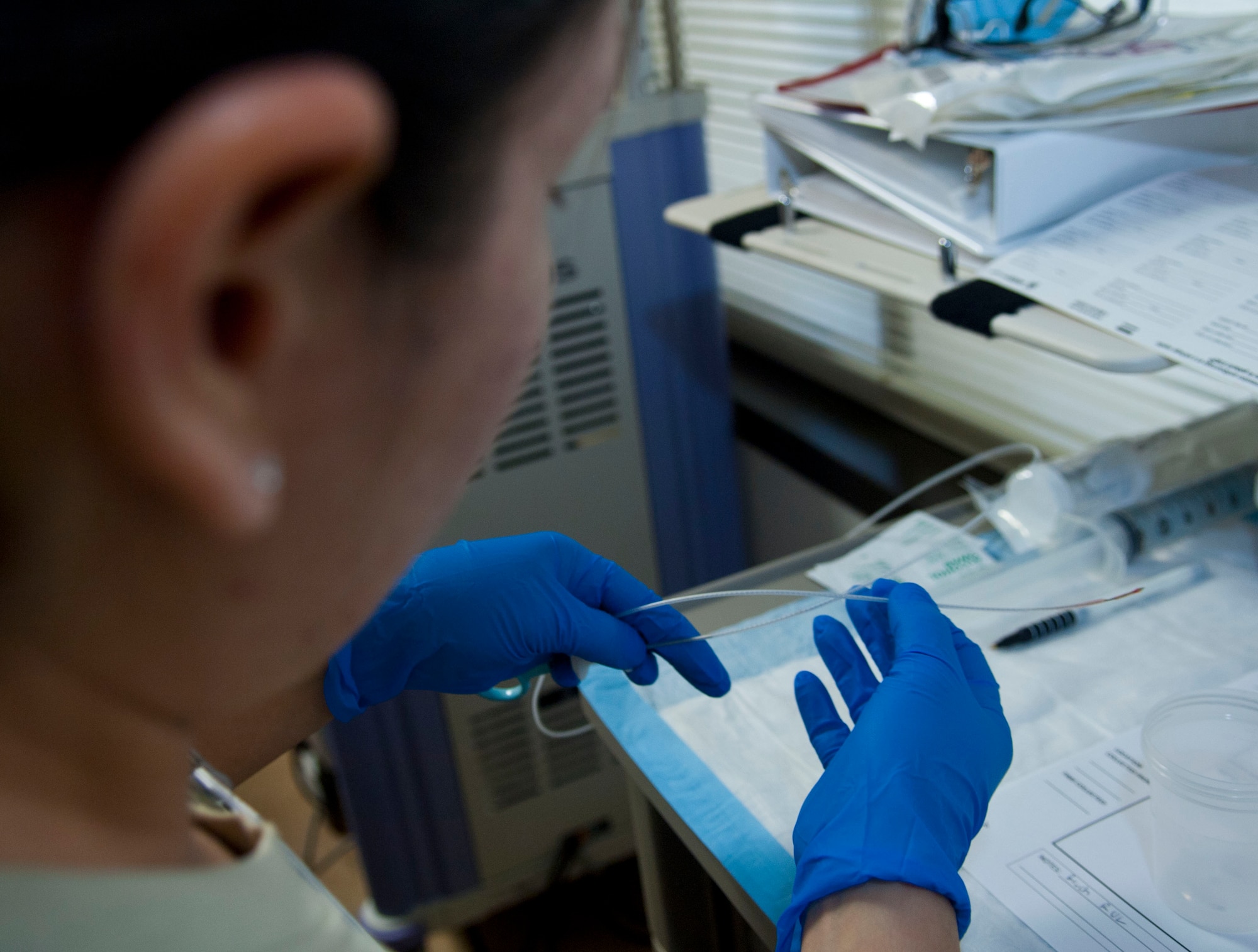 Senior Airman Dalia Mireles, 633rd Medical Group medical technician, prepares lung tissue samples after a bronchoscopy Feb. 12, 2013 at U.S. Air Force Hospital Langley, Va. The sample was sent to the hospital lab to determine if the patient had healthy lungs. (U.S. Air Force photo by Airman 1st Class Austin Harvill/Released)