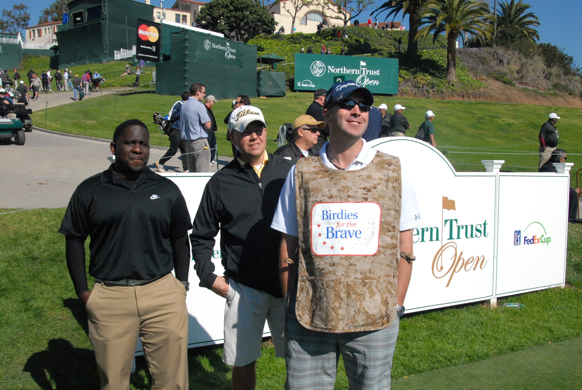 From left: Tech. Sgt. Brent Jnofinn, 412th Aerospace Medicine Squadron; Staff Sgt. Jeff Powell, 412th Maintenance Group; and Staff Sgt. Adam Shura, Air Force Test Center; stand on the tee box on the 10th hole at the Rivera Country Club in Pacific Palisades, Calif., Feb. 13.  The three got the chance to caddy for pro golfers during the Northern Trust Open tournament. (U.S. Air Force photo by Kenji Thuloweit)