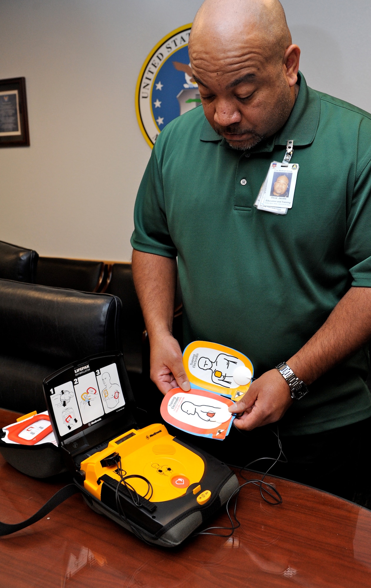 Oscar Jacobs, the training manager and basic life support program director with the 71st Medical Group, inspects an automated external defibrillator for treating heart-attack victims. Twelve of the AEDs were recently installed in buildings at Vance Air Force Base, Okla. (U.S. Air Force photo/ Airman 1st Class Frank Casciotta)
