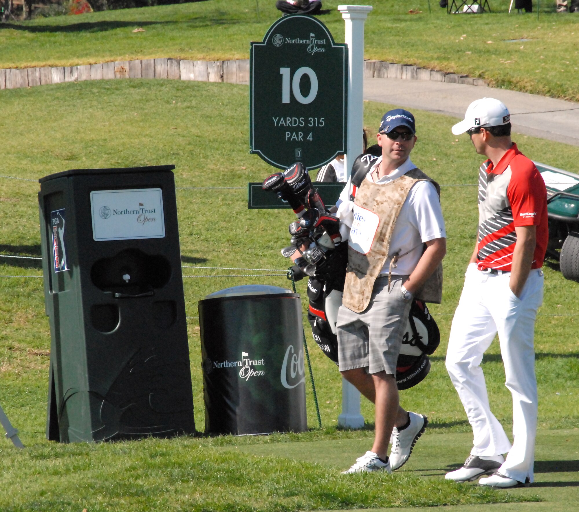 Staff Sgt. Adam Shura, Air Force Test Center, chats with English pro golfer Lee Westwood Feb. 13 on the 10th hole of the Norther Trust Open at the Riviera Country Club in Pacific Palisades, Calif. Shura and two other Airmen from Edwards got the chance to caddy for pro golfers.  Throughout the tournament week, military members received free admission to the tournament, which is an official Professional Golfers' Association event.  (U.S. Air Force photo by Melissa Buchanan)
