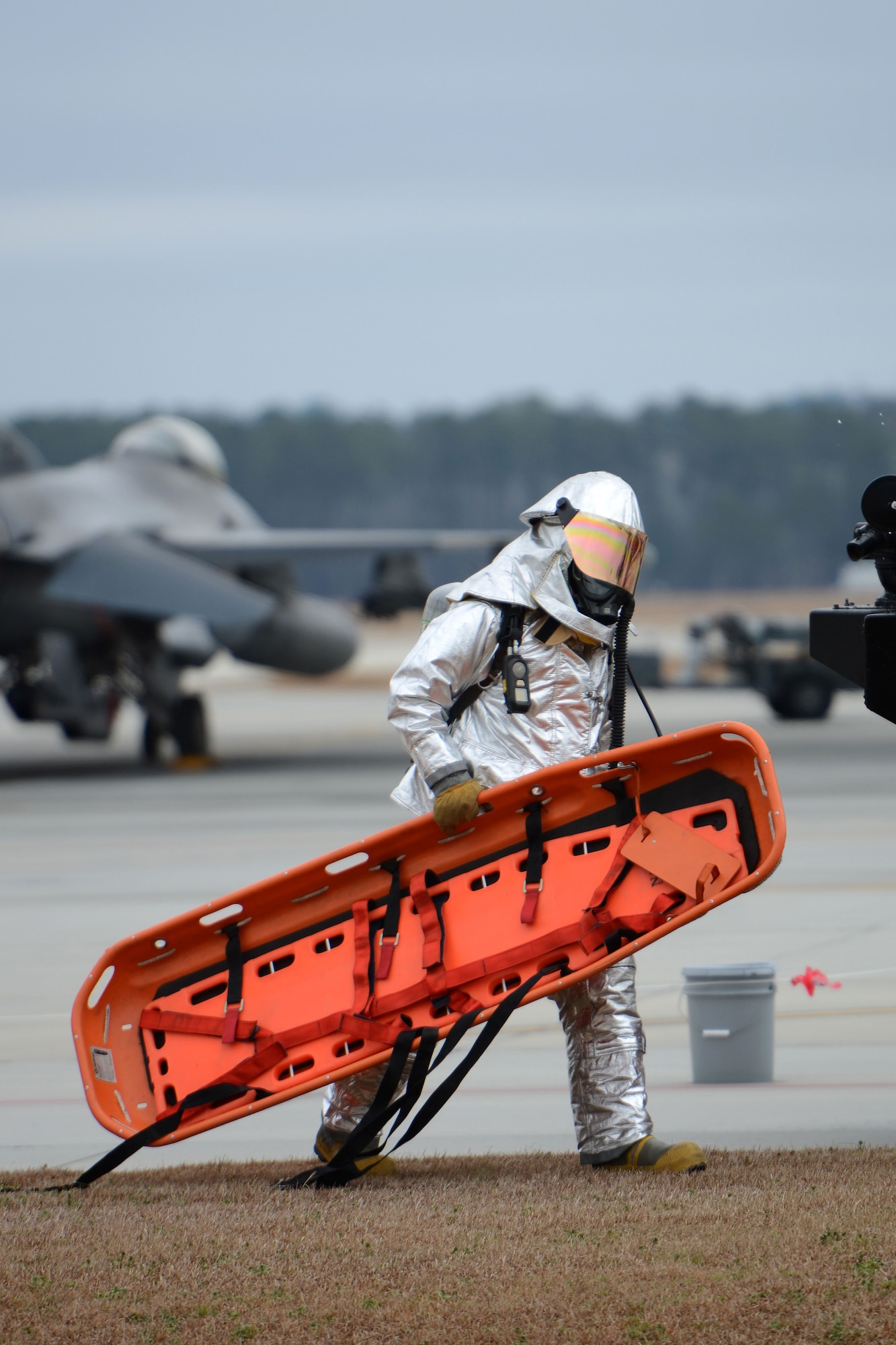 Firefighters with the 169th Civil Engineering Squadron at McEntire Joint National Guard Base, S.C., respond to a training scenario to remove a pilot from the cockpit of an F-16 Block 52 figher jet Feb. 8, 2013. The aircrew extraction training measures how quickly and safely emergency rescue personnel can remove an incapacitated pilot from a plane during an Operational Readiness Exercise. The 169th Fighter Wing is training for an upcoming Operational Readiness Inspection later this year. (National Guard photo by Tech. Sgt. Caycee Watson/Released)