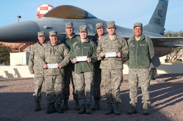 Representing the 162nd Fighter Wing Chief's Council are (back row, from left to right) Chief Master Sgts. Larry Cruce, Brian Karas, 162nd Fighter Wing Command Chief  Shane Clark  and Chief Master Sgt. Armando Gonzalez,162nd Fighter Wing Chief's Council President. The award recipients included (front row, from left to right) Staff Sgt. Mark Gregory, Tech. Sgt. Ashley Crocker and Staff Sgt. Kaleb Semler.