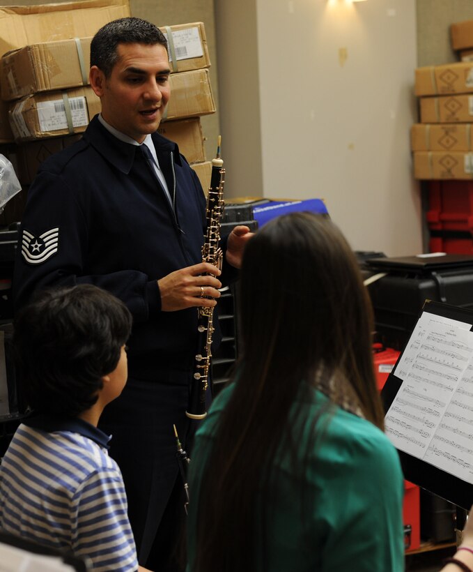 Tech Sgt. Kevin Darrow, U. S. Air Force Band Oboist, advises the students from the InterSchool Orchestra from N.Y., during a workshop Feb. 16, 2013, on Joint Base Anacostia-Bolling, D.C. Members of the Air Force Band volunteered to coach the students for their performance in D.C. the following day. (U.S. Air Force photo/Senior Airman Bahja Joi Jones)