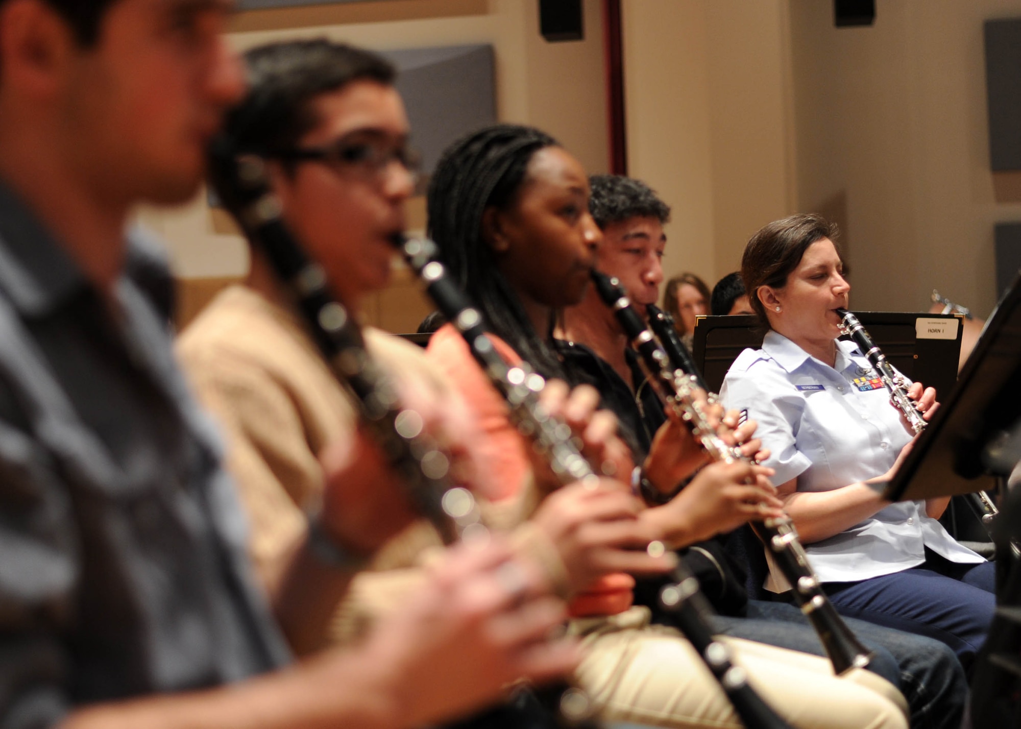 Tech Sgt. Ani Berberian, U.S. Air Force Band clarinetist, rehearses with students of the InterSchool Orchestra from N.Y., during a workshop Feb. 16, 2013, on Joint Base Anacostia-Bolling, D.C. Members of the Air Force Band volunteered to coach the students for their performance in D.C. the following day. (U.S. Air Force photo/Senior Airman Bahja Joi Jones) 