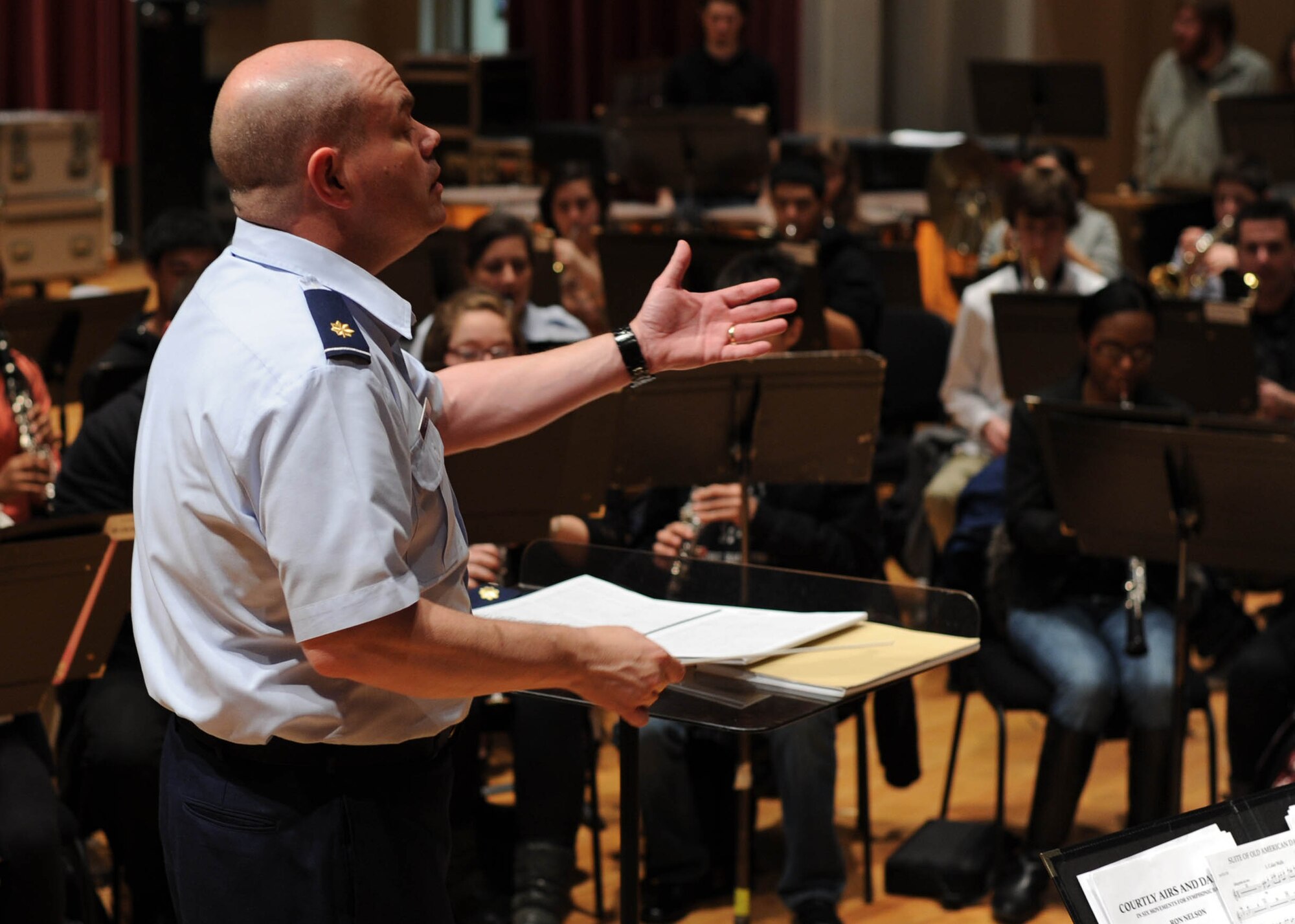 Maj. Scott Guidry, U.S. Air Force Band director of operations, conducts the symphonic band from the InterSchool Orchestra from N.Y., during a workshop Feb. 16, 2013, on Joint Base Anacostia-Bolling, D.C. Members of the Air Force Band volunteered to coach the students for their performance in D.C. the following day. (U.S. Air Force photo/Senior Airman Bahja Joi Jones)