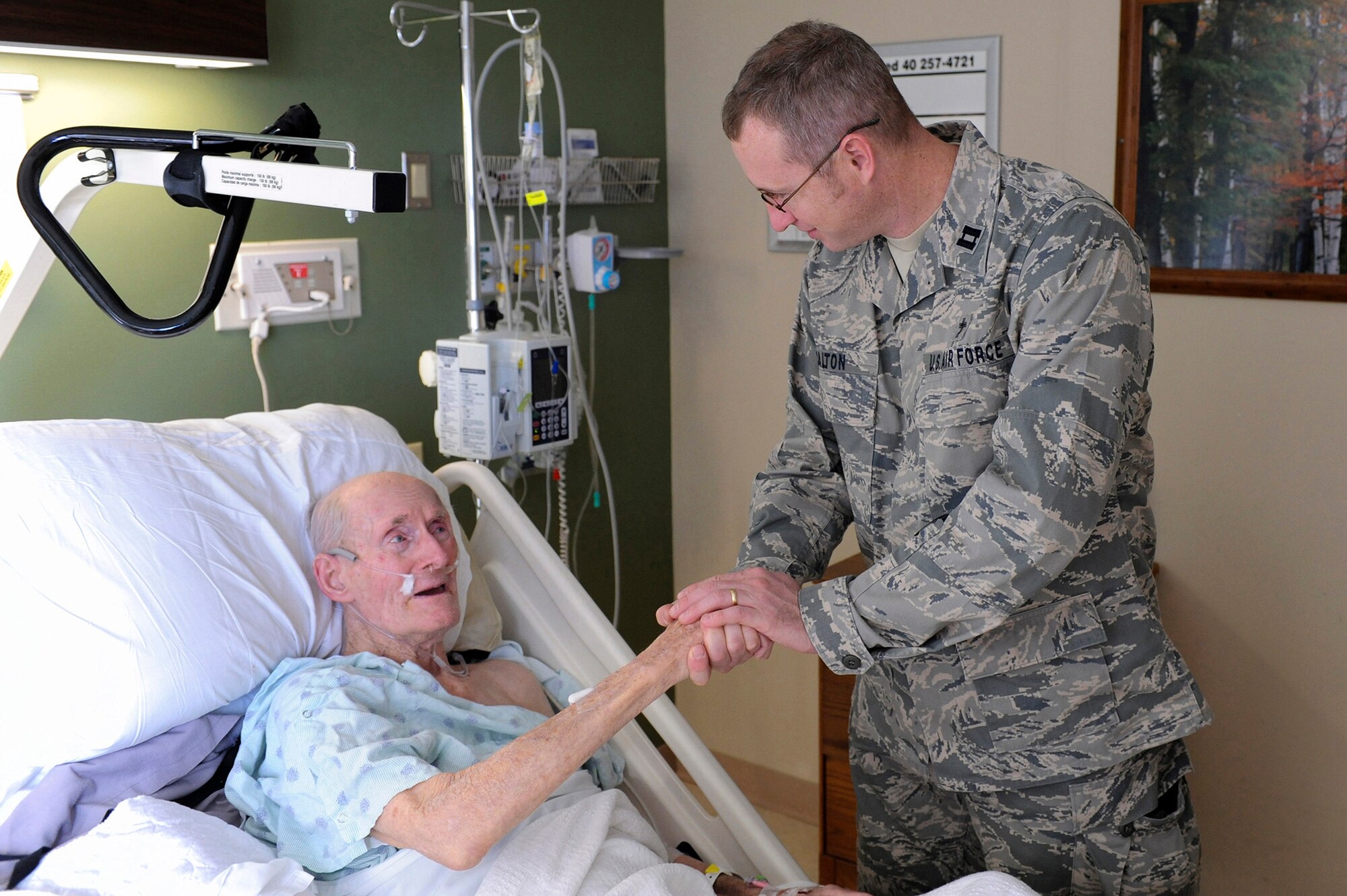 Chaplain (Capt.) Garrell Calton, a 19th Airlift Wing chaplain, visits a patient inside a veterans’ hospital Dec. 18, 2012, at Little Rock, Ark. Calton visits VA hospitals at least once a week as a part of his chaplain duties.(U.S. Air Force photo by Airman 1st Class Rusty Frank)