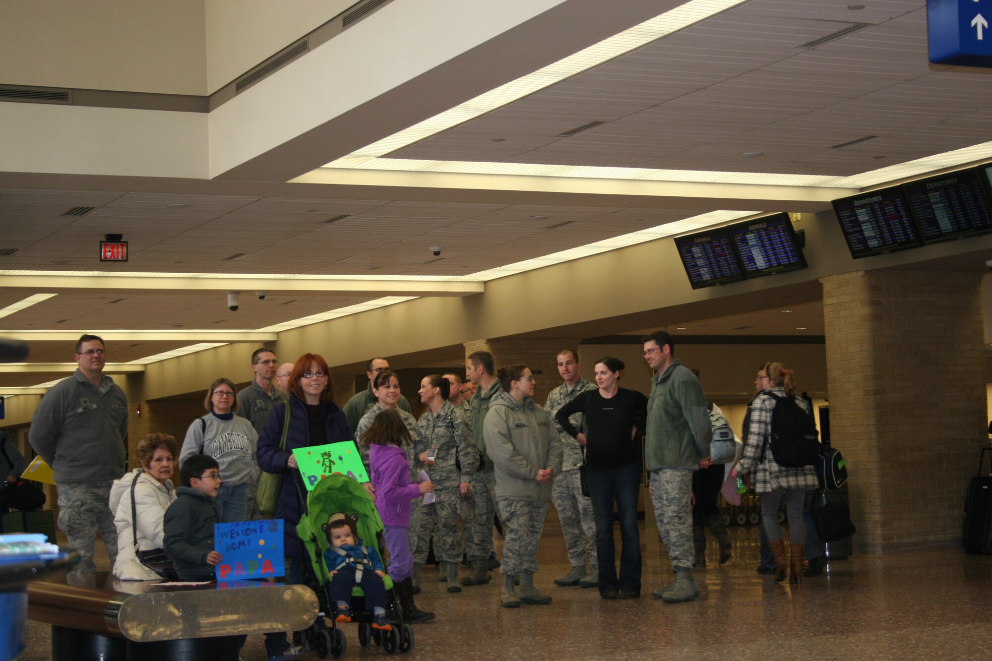 Members of the Heartland of America Band await the arrival of Commander First Lieutenant Rafael Toro-Quiñones from deployment overseas.