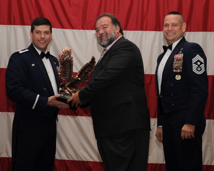 Trina McClure, 2nd Mission Support Group, 2nd Bomb Wing Category IV Civilian of the Year. Accepting on her behalf is Alex Vega.