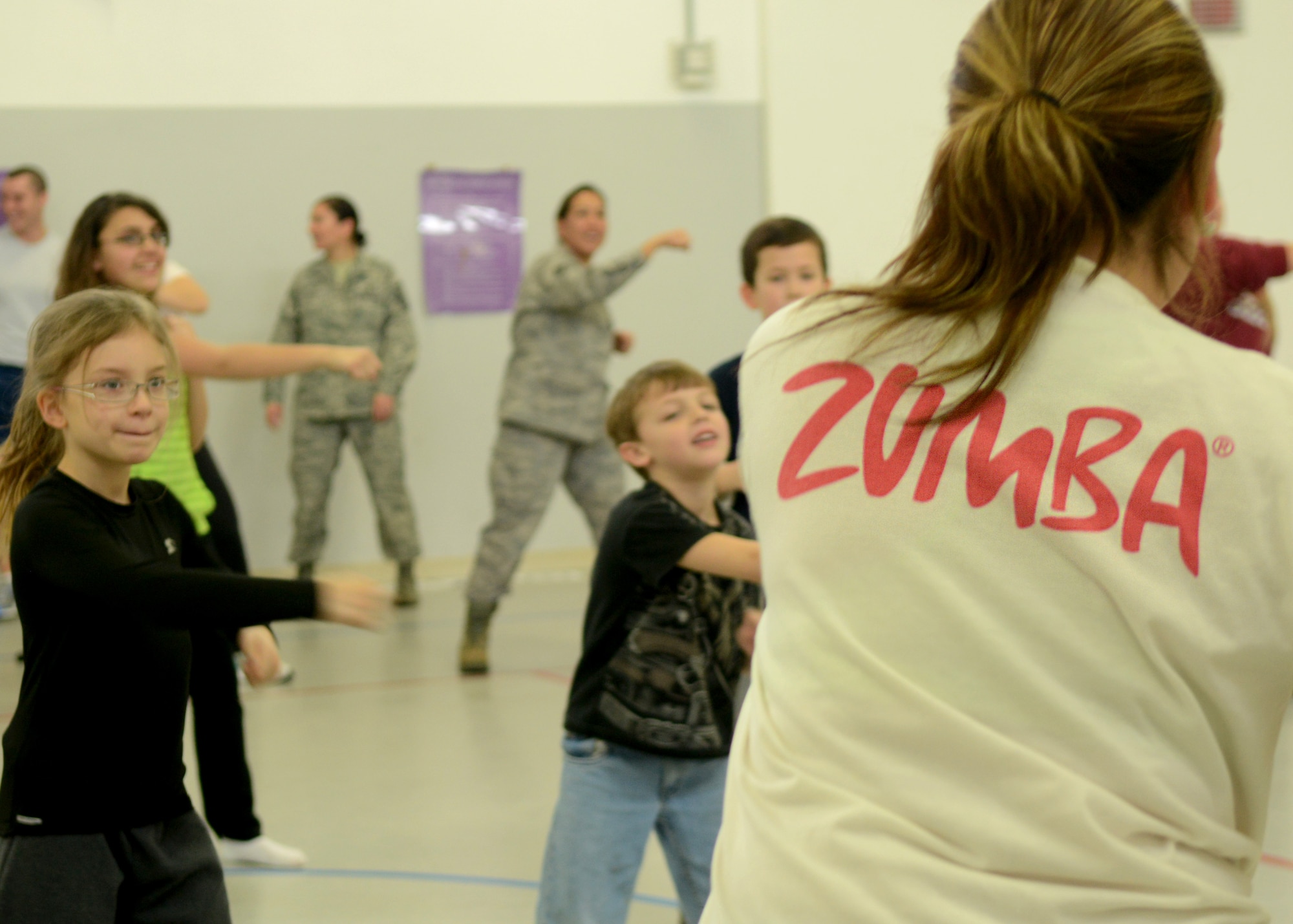 Tatiana Rodriguez, 31st Force Support Squadron Zumba fitness instructor, teaches a class to children during the Kid Fit Seminar Jan. 24 at Aviano Air Base, Italy. The seminar included educational briefings on a variety of health issues effecting children today. (U.S. Air Force photo/Airman 1st Class Briana Jones)