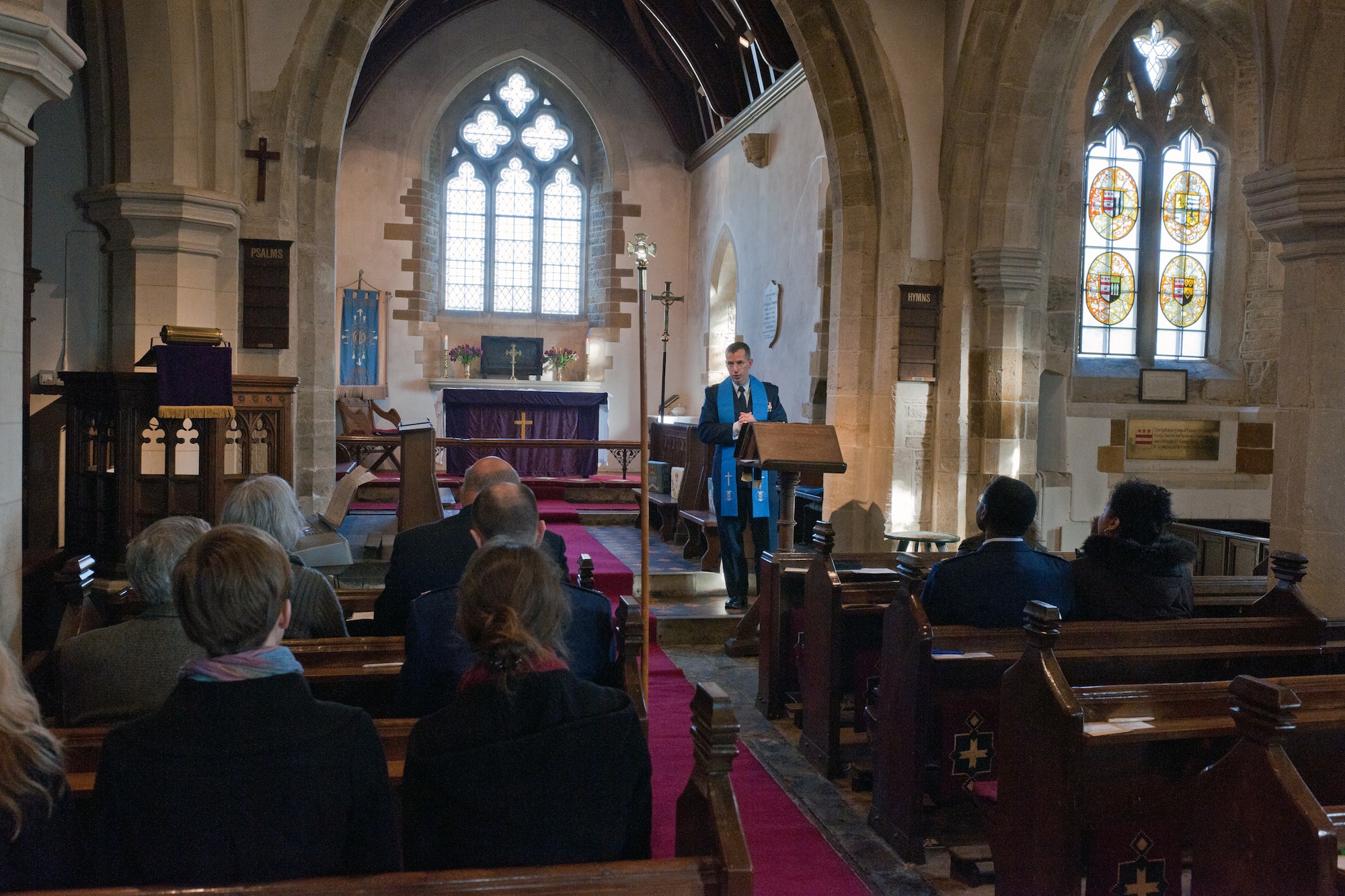 SULGRAVE, United Kingdom - Ch. (Maj.) Peter Fischer, 501st Combat Support Wing chaplain, gives a sermon at the parish church of St. James the Less in Sulgrave Feb. 17. The church dates from the 13th century, and has been designated by English Heritage as a Grade II listed building. To the left of Fischer is the pew where the Washington family worshipped on Sundays; the tomb of Lawrence Washington, George Washington’s five-time great grandfather; and a window bearing four stained-glass versions of the family coat of arms. (U.S. Air Force photo by Staff Sgt. Brian Stives)
