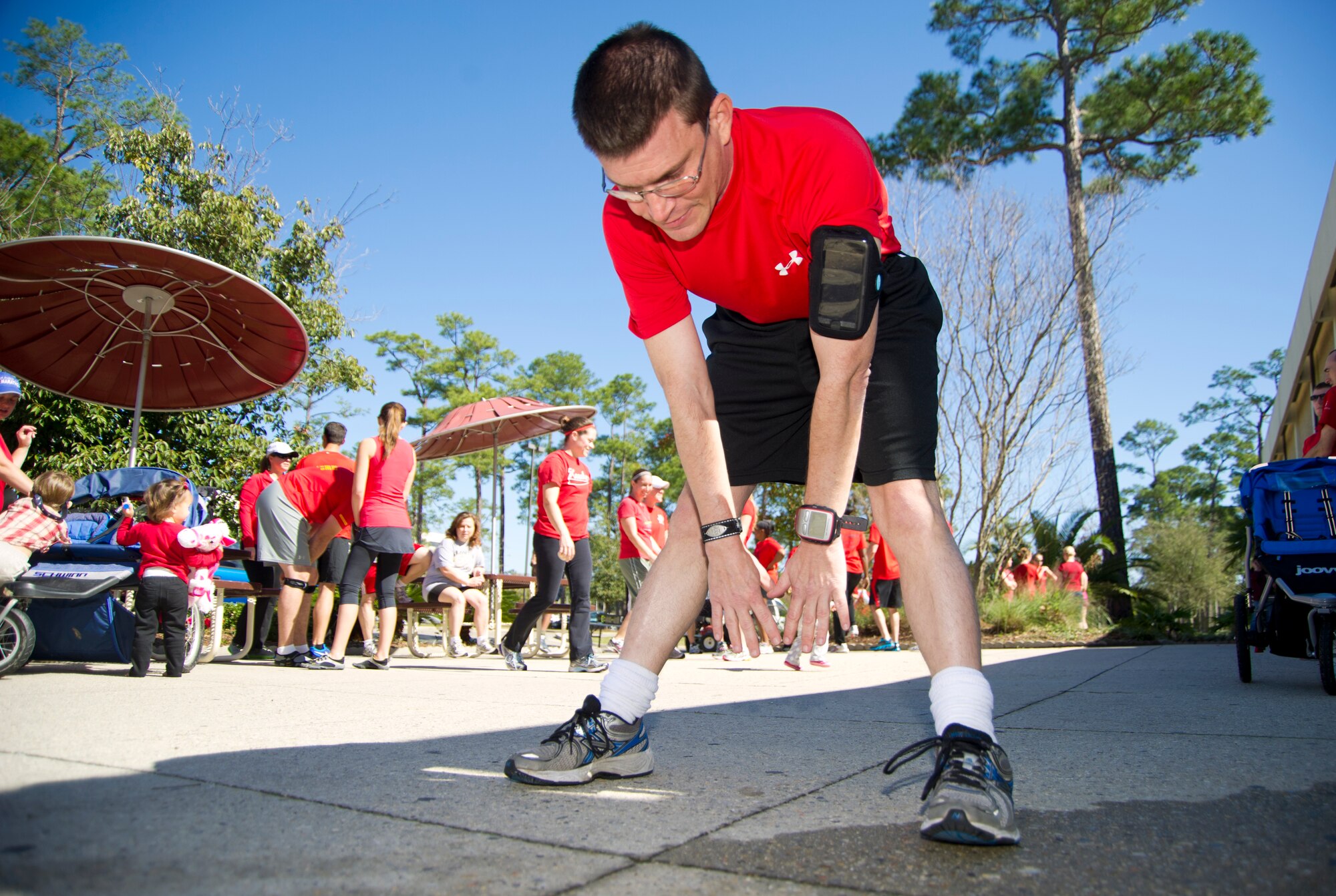 Retired Master Sgt. Michael Raff, 338th Training Squadron instructor, stretches before participating in the Healthy Heart 5-kilometer run/walk Feb. 15, 2013, at the Blake Fitness Center, Keesler Air Force Base, Miss.  Raff said he owes his life to a physical training regimen engrained in him through the Air Force after he underwent open heart surgery in late November, 2012.  (U.S. Air Force photo by Adam Bond)