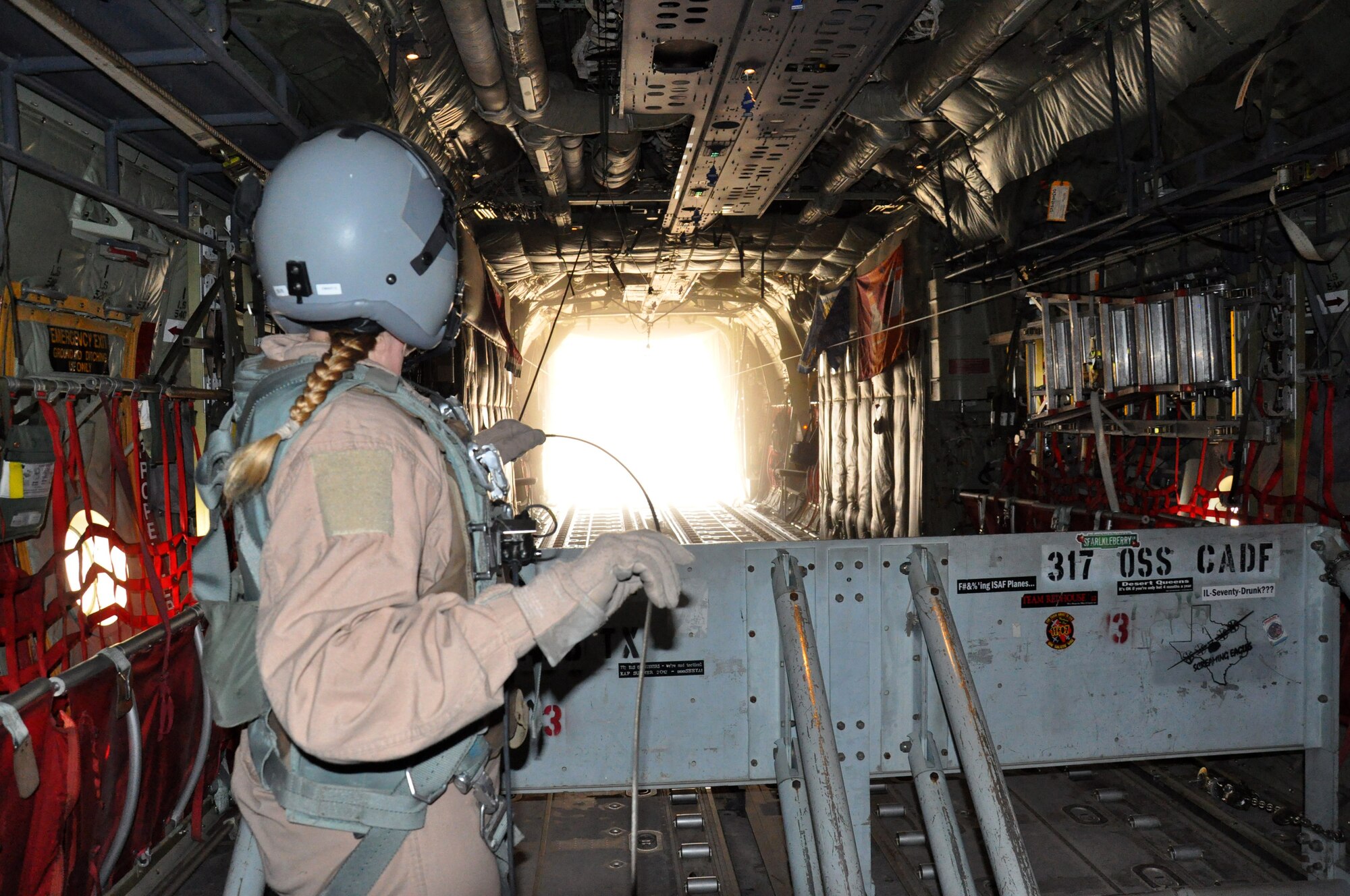 Master Sgt. Tracey Smith, 772nd Expeditionary Airlift Squadron loadmaster, releases an airdrop, containing food and fuel for troops from a C-130J Feb. 14, 2013, above southern Afghanistan. Smith is one of many deployed 317th Airlift Group Airmen from Dyess Air Force Base, Texas, currently assigned to the 772nd EAS. (U.S. Air Force photo by Capt. Tristan Hinderliter/Released)