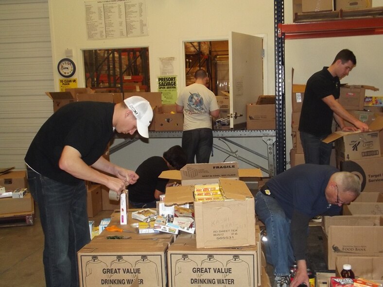 From left to right: Senior Airman Andrew Hoffman, Airmen 1st Class Herzyl Legaspi and Steven Galioto, Mark Snyder and Senior Eric Florance, all from the 82nd Contracting Squadron, package food donations at the Wichita Falls Area Food Bank Feb. 16, 2013.  The 82nd CONS helped prep over 3,500 pounds of food for those in need. (U.S. Air Force courtesy photo)