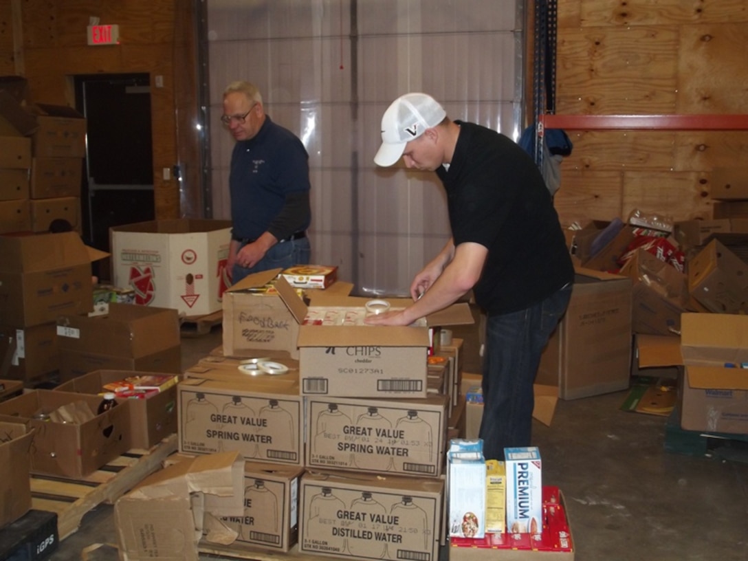 Senior Airman Andrew Hoffman (right) and Mark Snyder, 82nd Contracting Squadron, package food donations at the Wichita Falls Area Food Bank Feb. 16, 2013.  The 82nd CONS helped prep over 3,500 pounds of food for those in need. (U.S. Air Force courtesy photo
