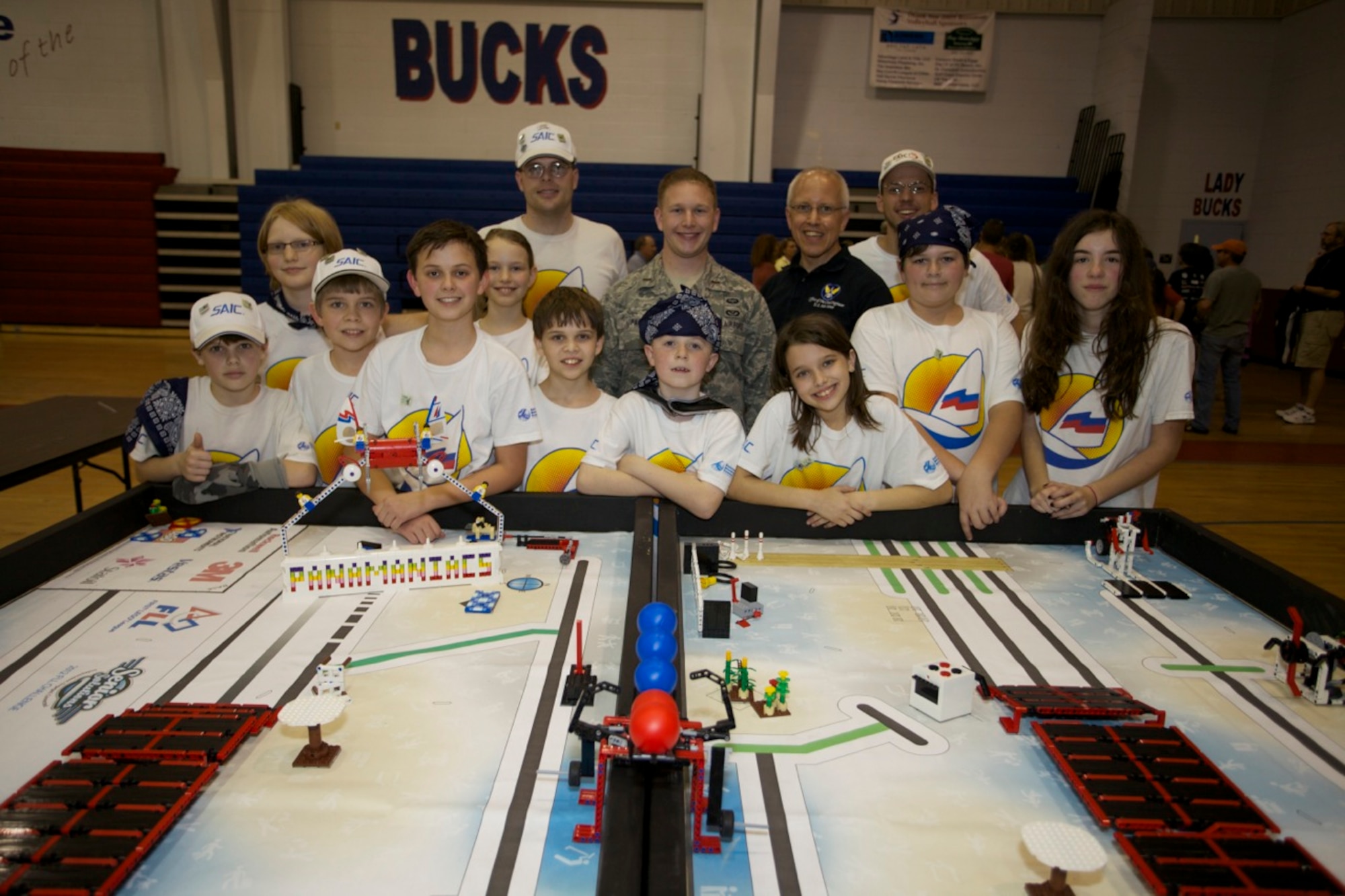 PANAMA CITY, Fla. -- Air Force Civil Engineer Center engineers 2nd Lt. William Page and Bryan Muller (back row, 2nd and 3rd from left), pose with teams from the Panama City, Fla., Science and Discovery Center during the First Lego League robotics competition Jan. 12, 2013. Page and Muller, both assigned to Tyndall Air Force Base, Fla., were judges for the robot design portion of the competition. (U.S. Air Force photo/Eddie Green)