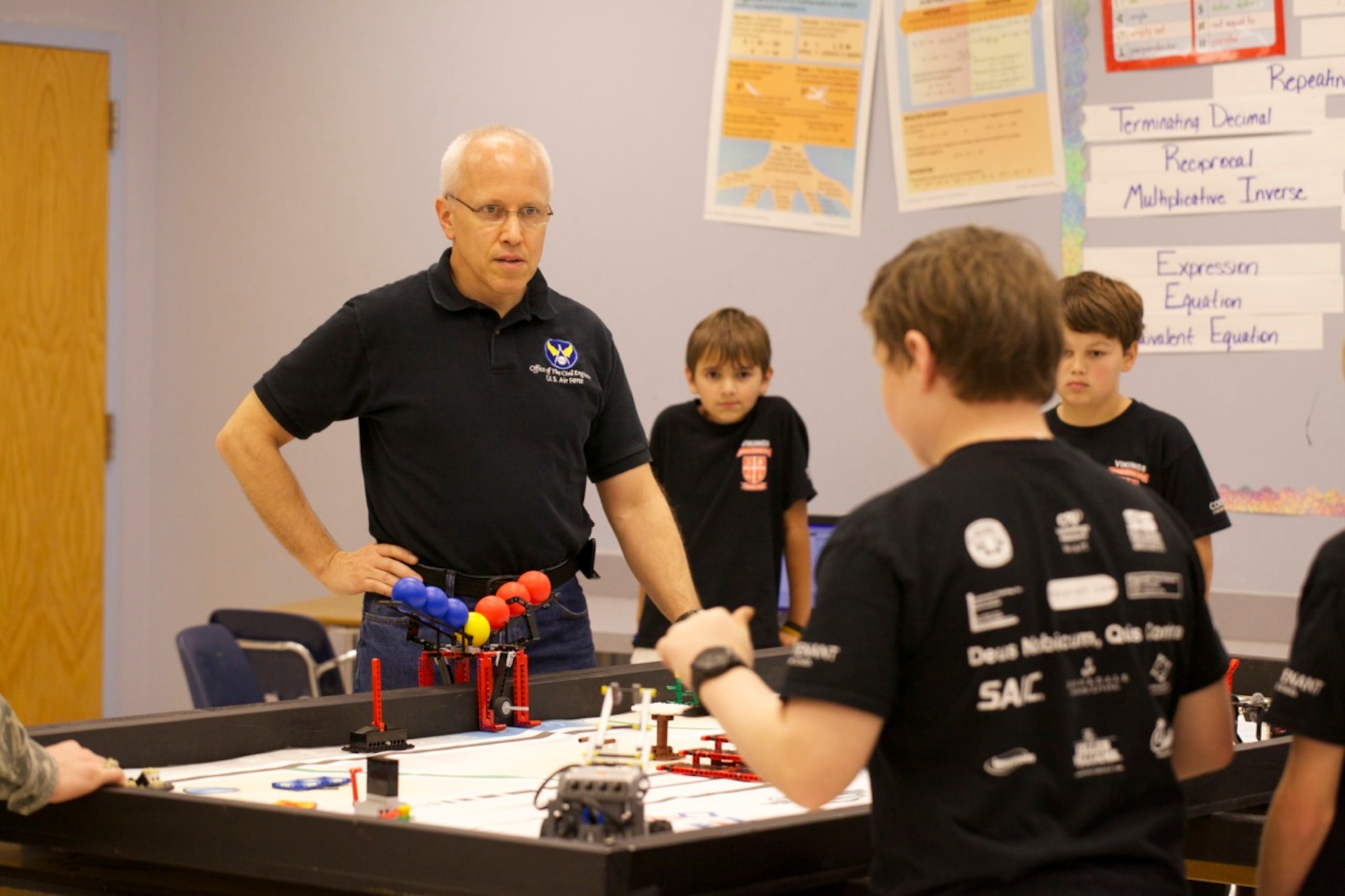 PANAMA CITY, Fla. -- Air Force Civil Engineer Center engineer Bryan Muller listens as a team of students from Covenant Christian School, Panama City, Fla., explain how they designed their robot for the First Lego League robotics compeition Jan. 12, 2013. Muller, assigned to AFCEC at Tyndall Air Force Base, Fla., was a judge for the design portion of the competition. (U.S. Air Force photo/Eddie Green)