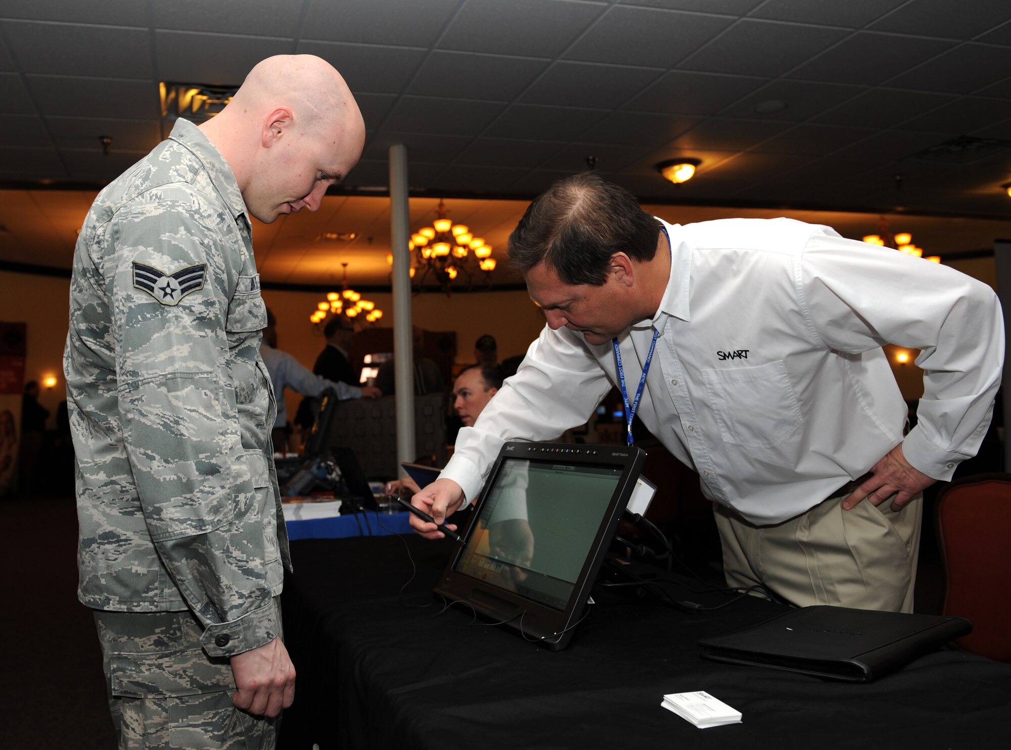 Senior Airman Collin Bates, 2nd Communications Squadron cyber transport, watches a demonstration of an interactive whiteboard at the Information Technology Expo on Barksdale Air Force Base, La., Feb. 19. The exposition gave members of Team Barksdale the opportunity to view the latest technology the industry has to offer for military and personal use. (U.S. Air Force photo/Airman 1st Class Benjamin Gonsier)
