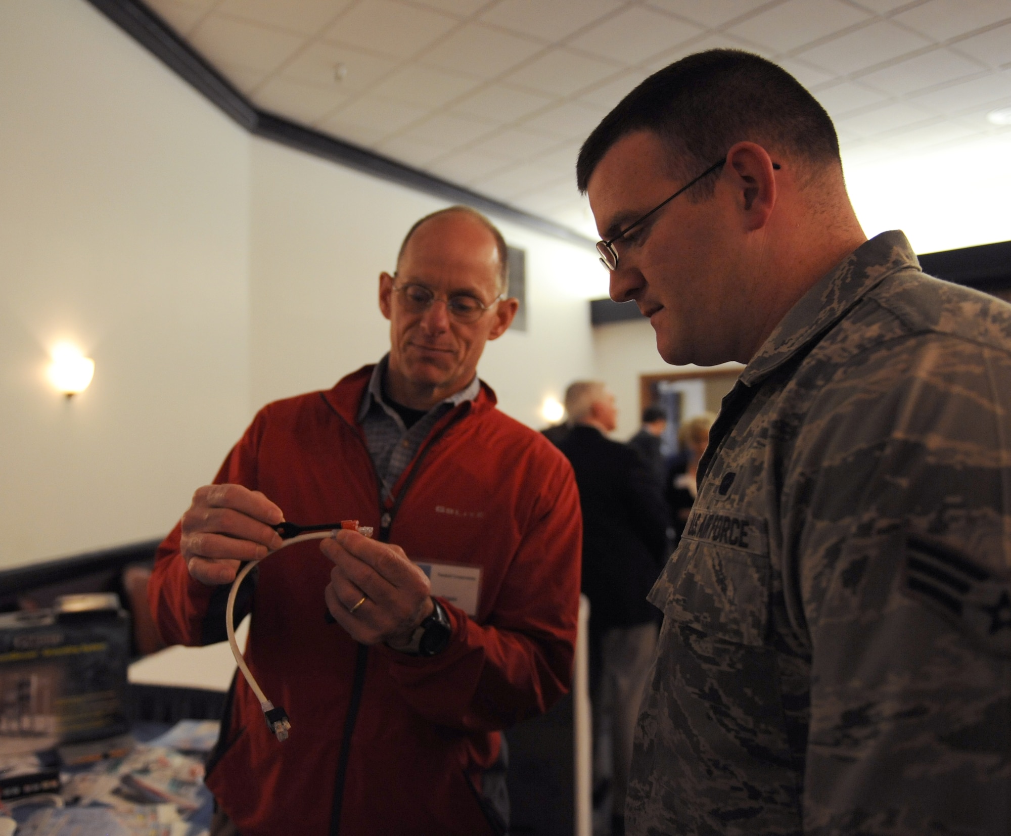 Senior Airman Brandon Lambert, 2nd Communications Squadron, looks at a network cable at the Information Technology Expo on Barksdale Air Force Base, La., Feb. 19. The exposition gave members of Team Barksdale the opportunity to view the latest technology the industry has to offer for military and personal use. (U.S. Air Force photo/Airman 1st Class Benjamin Gonsier)
