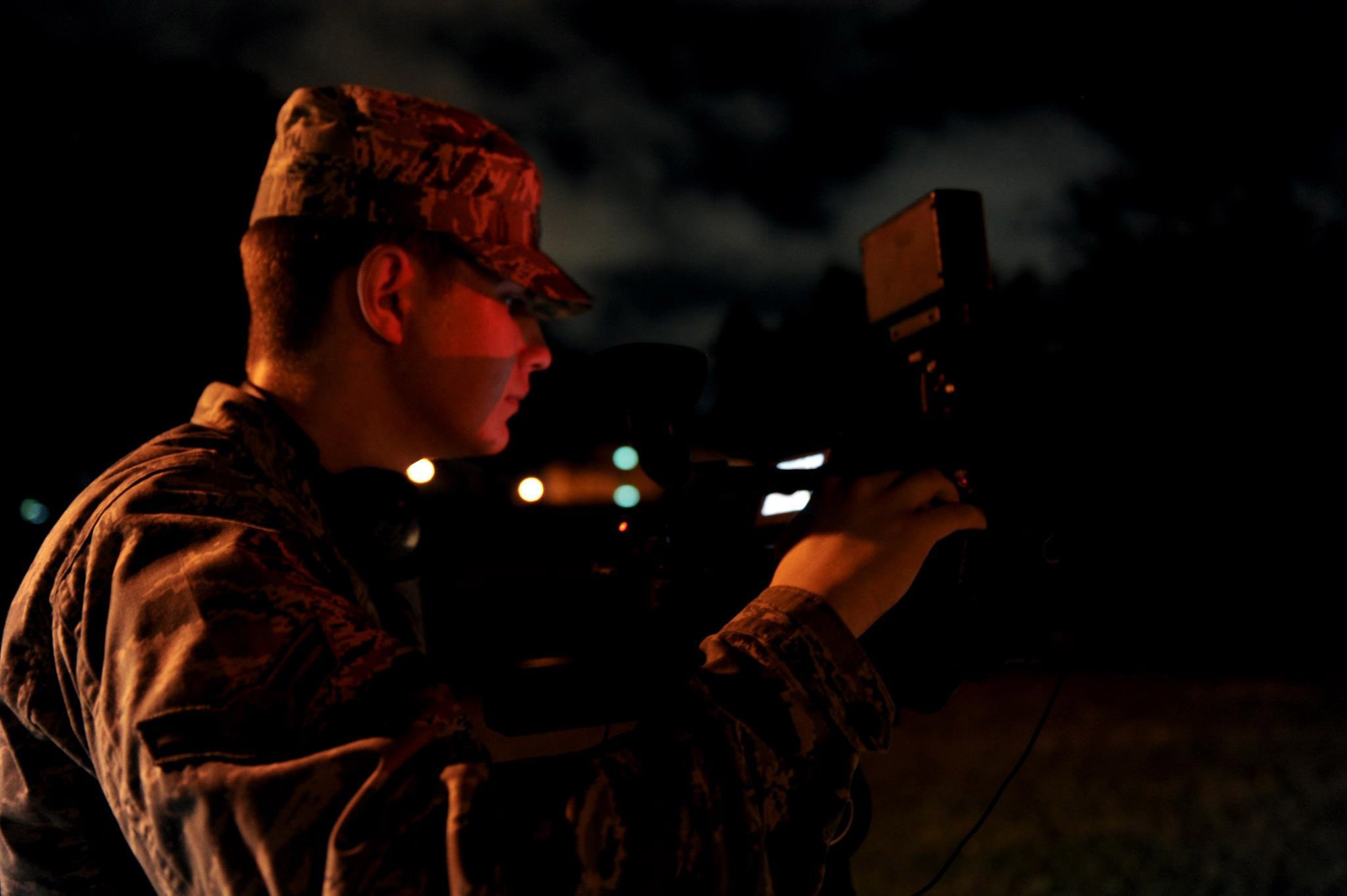 U.S. Air Force Airman 1st Class William Hupp, 18th Wing Public Affairs broadcaster, records footage of a gate runner during a local operational readiness exercise on Kadena Air Base, Japan, May 16, 2012. The footage was used in a story about how the 18th Security Forces Squadron responds to unauthorized entries through Kadena's gates. (U.S. Air force photo/Airman 1st Class Brooke P. Doyle)