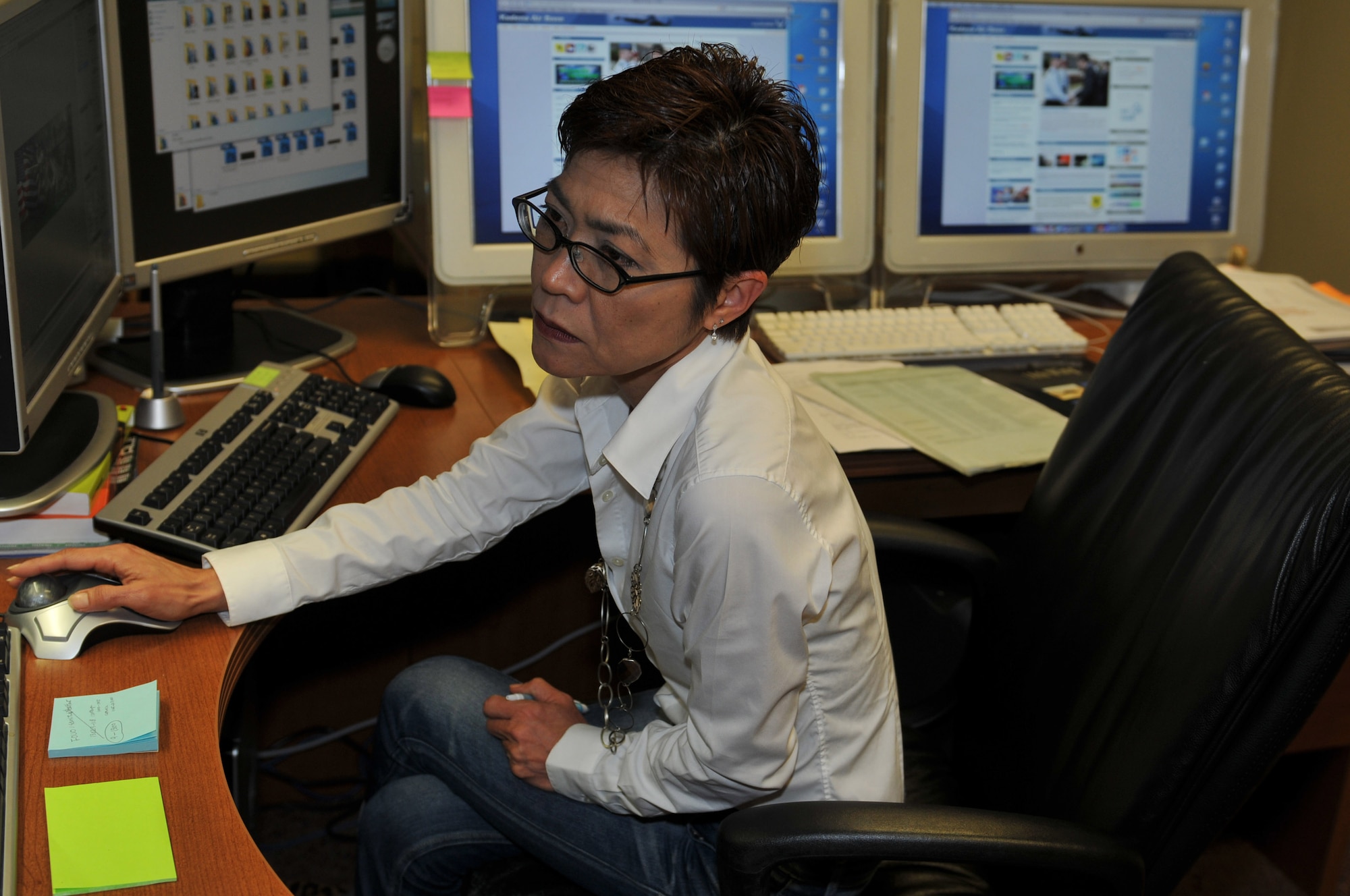 Naoko Shimoji, 18th Wing Public Affairs graphic design artist, updates the 18th Wing home page on Kadena Air Base, Japan, Feb. 14, 2013. Shimoji helps to provide graphic support for various units and web content. (U.S. Air Force photo/Airman 1st Class Keith A. James)