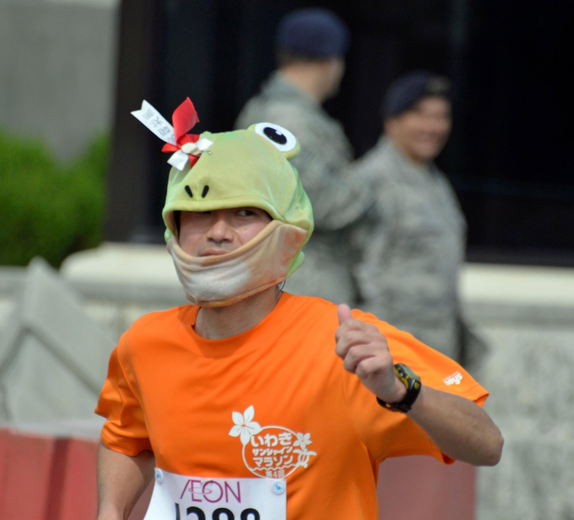 A participant in the 2013 Okinawa Marathon exits Kadena's Gate 5, ending the base's portion of the 2013 Okinawa Marathon on Kadena Air Base, Japan, Feb. 17, 2013. Team Kadena supported the Okinawa Marathon by providing 2.8 km of the 42-km marathon route. Hundreds of volunteers also supported more than 11,000 runners in the race. (Courtesy photo/Les Gray)