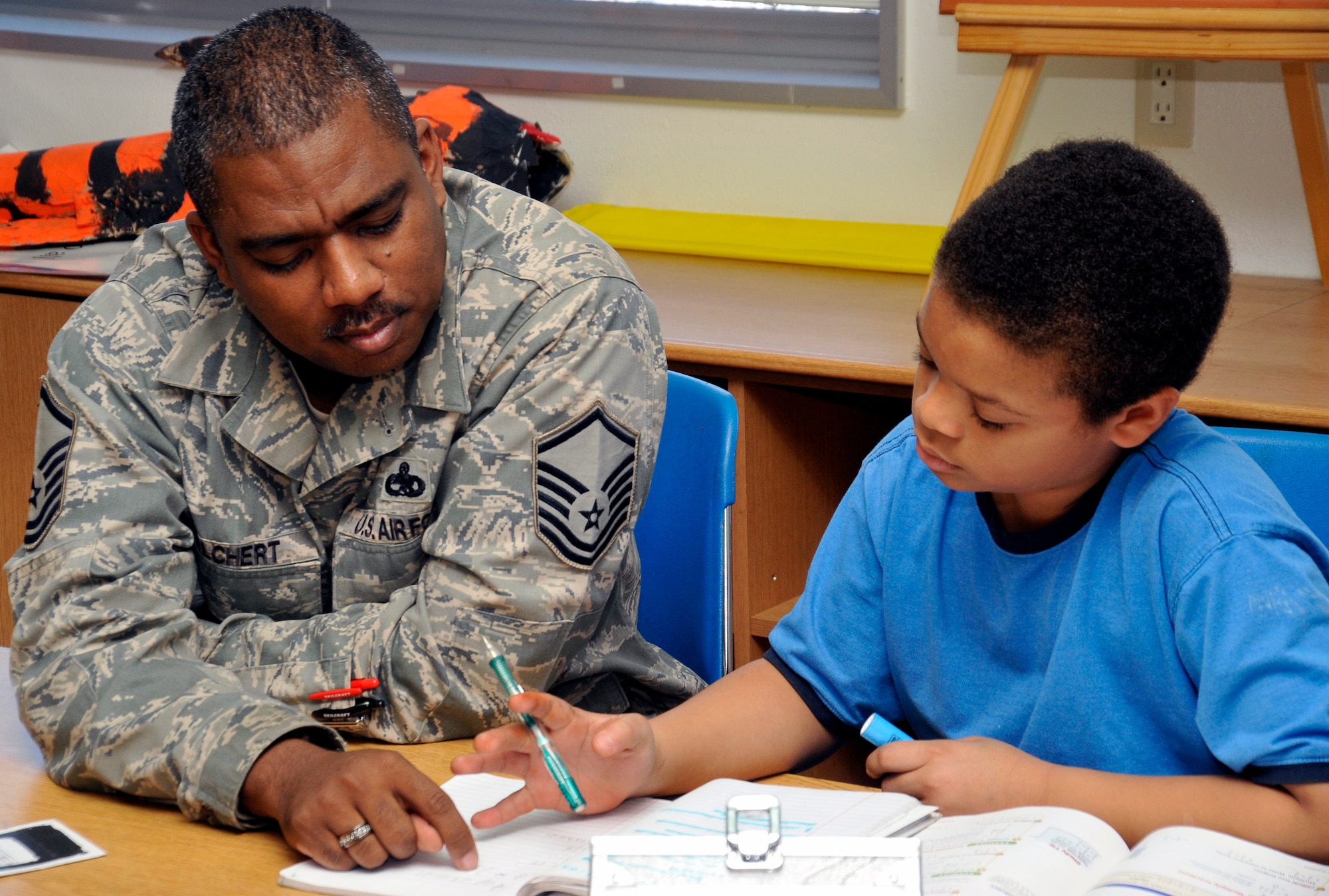 U.S. Air Force Master Sgt. Nathan Welchert, 35th Fighter Wing Flight Safety NCO in charge and Dragon Academy volunteer, helps a Sollars Elementary School sixth grader with math problems at Misawa Air Base, Japan, Feb. 14, 2013. The purpose of the Dragon Academy is to build a relationship between students and service members while helping the school reach a high student achievement level. If you want to volunteer for the Dragon Academy Program, contact Sollars Elementary School at 226-3933. (U.S. Air Force photo by Airman 1st Class Zachary Kee)