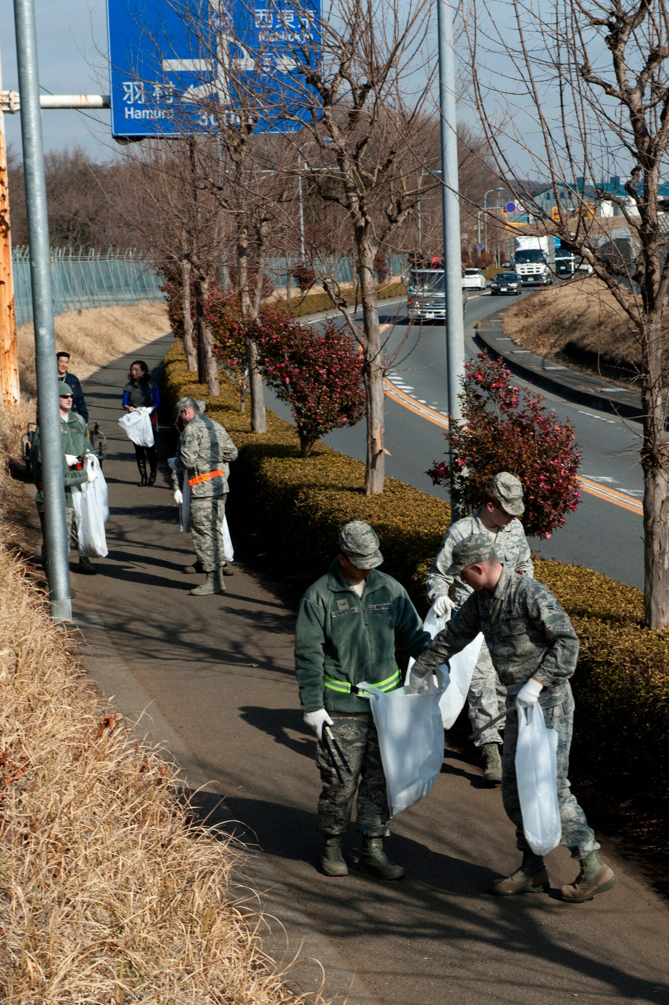 MIZUHO-TOWN, Japan -- Airman pick up trash along the highway in Mizuho-town, Japan, Feb. 14, 2013.  The efforts of the Mizuho cleanup project started in 2005 and it encourages the surrounding host nations to lead cleanup projects. (U.S. Air Force photo by Airman 1st Class Meagan Schutter)