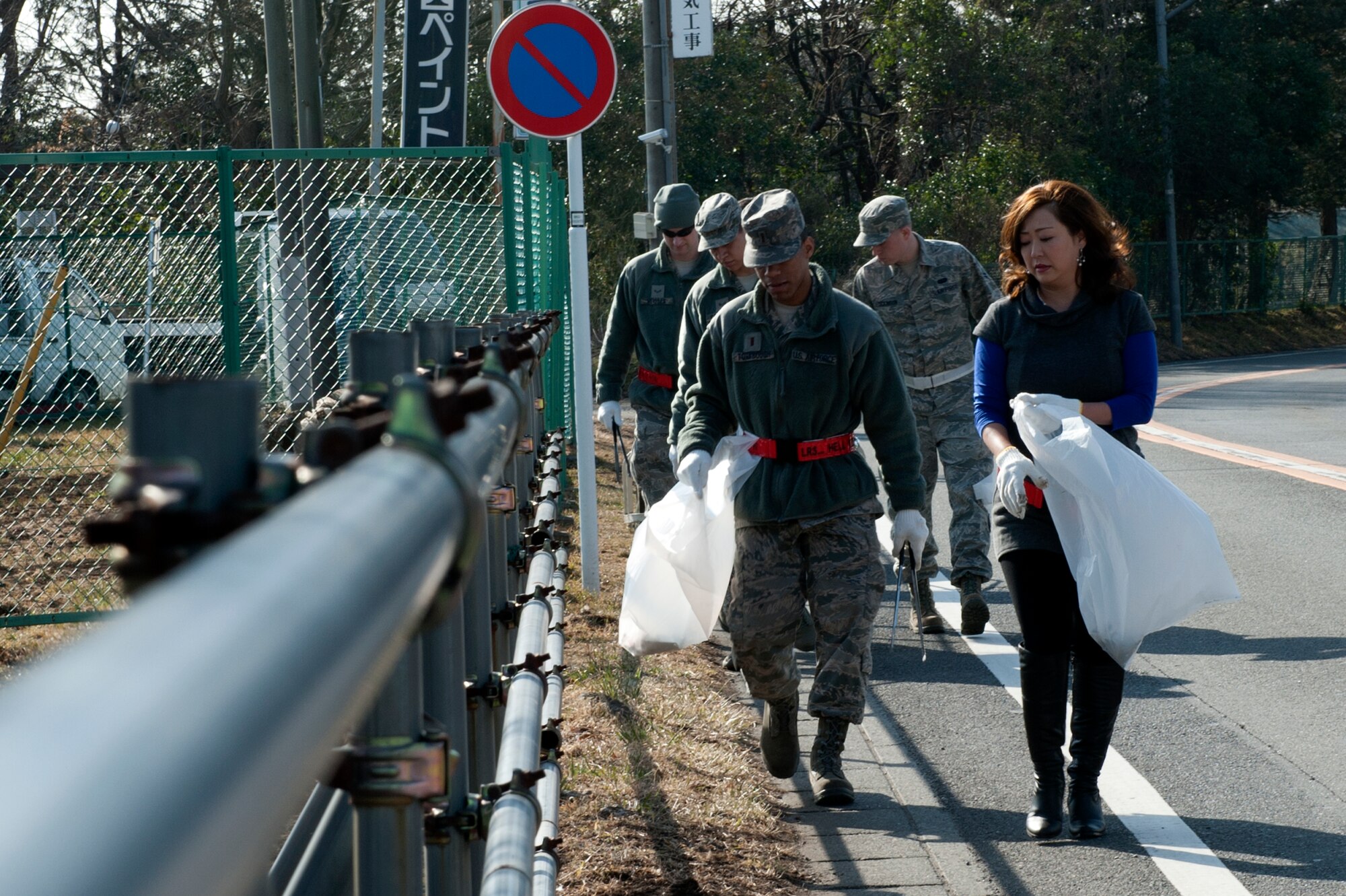 MIZUHO-TOWN, Japan -- Volunteers for the Mizuho-town cleanup project look for trash to pick up in Mizuho-town, Japan, Feb. 14, 2013.  Throughout the year, nearly four thousand pounds of trash is collected in the local area. (U.S. Air Force photo by Airman 1st Class Meagan Schutter)
