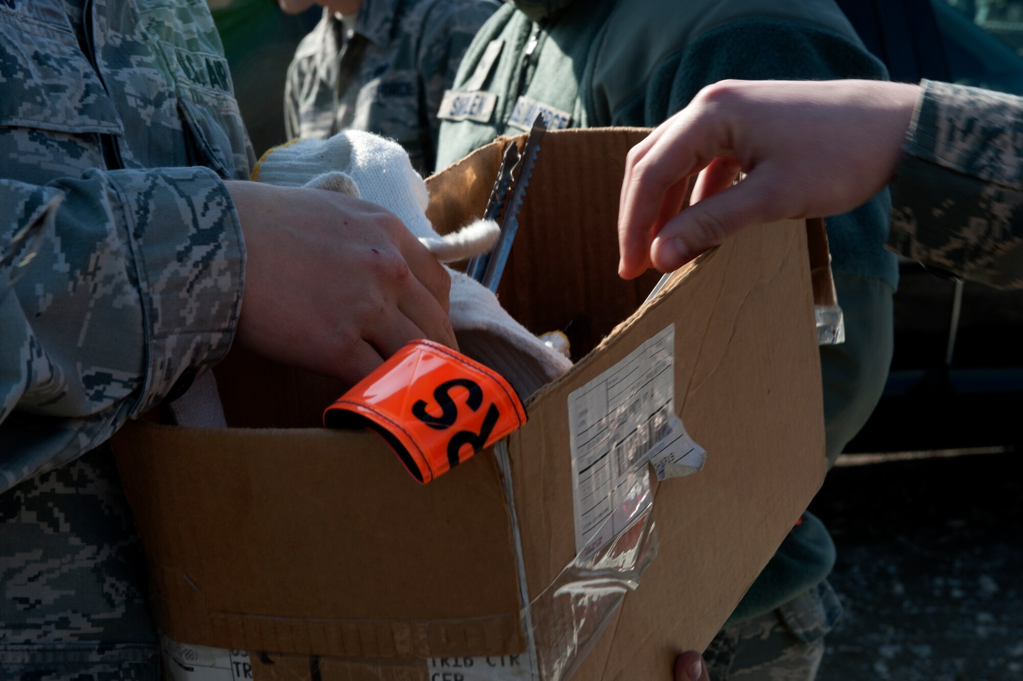 MIZUHO-TOWN, Japan -- Equipment is handed out prior to volunteers picking up trash off-base in Mizuho-town, Japan, Feb. 14, 2013.  This is done once a month to help clean up the surrounding area off base.  (U.S. Air Force photo by Airman 1st Class Meagan Schutter)