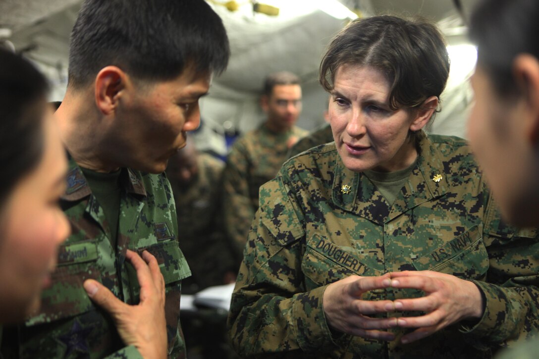Lieutenant Cmdr. Angela Dougherty, critical care clinical nurse specialist with 3rd Medical Battalion, III Marine Expeditionary Force, explains the capabilities of the 31st Marine Expeditionary Unit's forward resuscitative surgical suite to a group of Royal Thai Army medical personnel here, Feb. 16. The RTA medical visit helps the U.S. medical staff set protocols for the treatment of any incoming Thai personnel during exercise Cobra Gold 2013. CG13, now in its 32nd iteration, is an annual multilateral exercise aimed at strengthening military interoperability and foreign relationships while maintaining theatre security throughout the Asia-Pacific region.