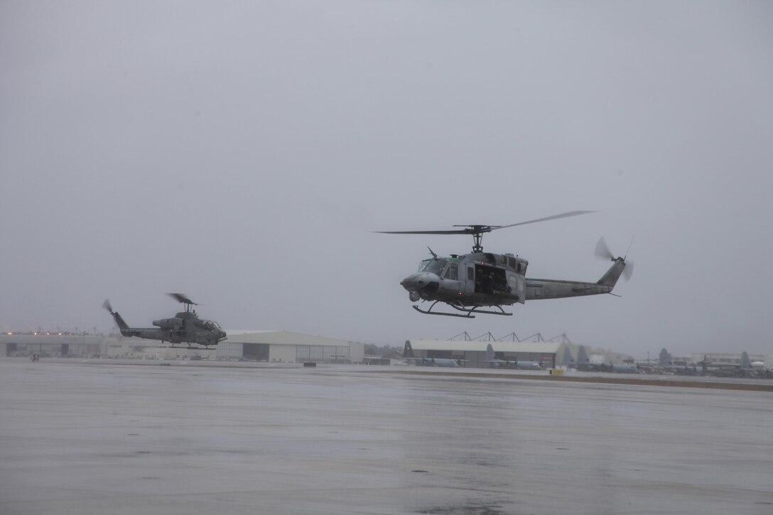 A UH-1N Huey with Marine Light Attack Helicopter Squadron 467 hovers above the flight line at Marine Corps Air Station Cherry Point Tuesday before conducting forward air controller instructor training. While many aboard the air station did their best to stay warm and dry during wet weather conditions, 2nd Marine Aircraft Wing Marines braved the elements to train and stay mission ready. Forward air controllers direct and control close air support missions, said 1st Lt. Timothy C. Nolan, AH-1W Cobra pilot with HMLA-467. “FACs control other aircraft from the sky,” he said. “They tell the other aircraft who to attack, and they can direct personnel to engage targets with their weapons.”