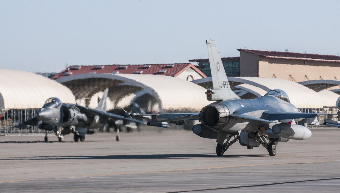 An F-16 from the Royal Netherlands Air Force prepares for takeoff along with AV-8B Harriers of Marine Attack Squadron 214 at Marine Corps Air Station Yuma, Ariz. Feb. 7, 2013. The RNLAF detachment is conducting aviation training in Yuma for three weeks before returning to the Netherlands.
